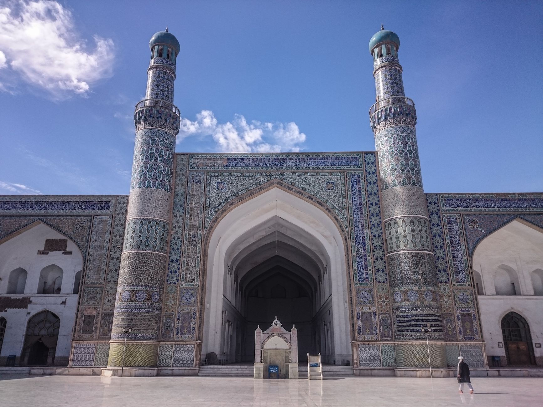 Expansive courtyard and ornate geometric tile arches of the historic Great Mosque in Herat, western Afghanistan