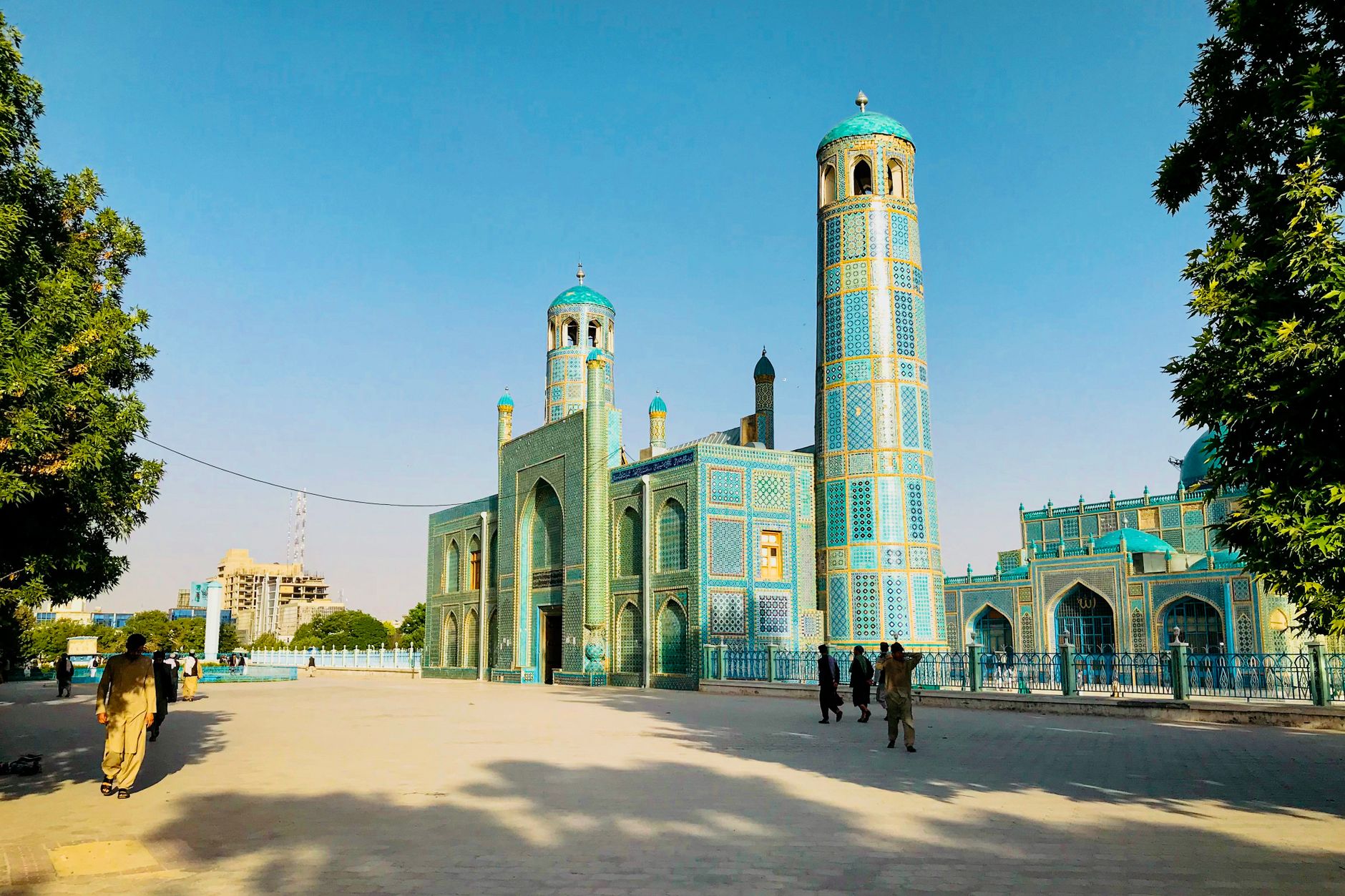 Exterior courtyard and cobalt blue mosaic domes of the historic Shrine of Hazrat Ali in Mazar-i-Sharif