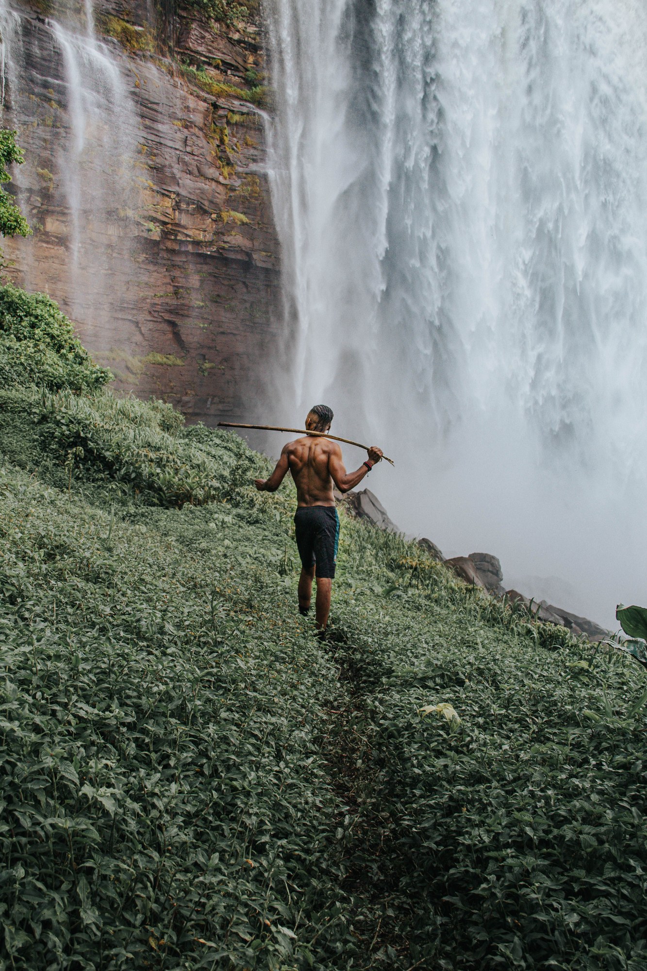 Expansive view of roaring waterfall cascading over broad rock rim in Angola