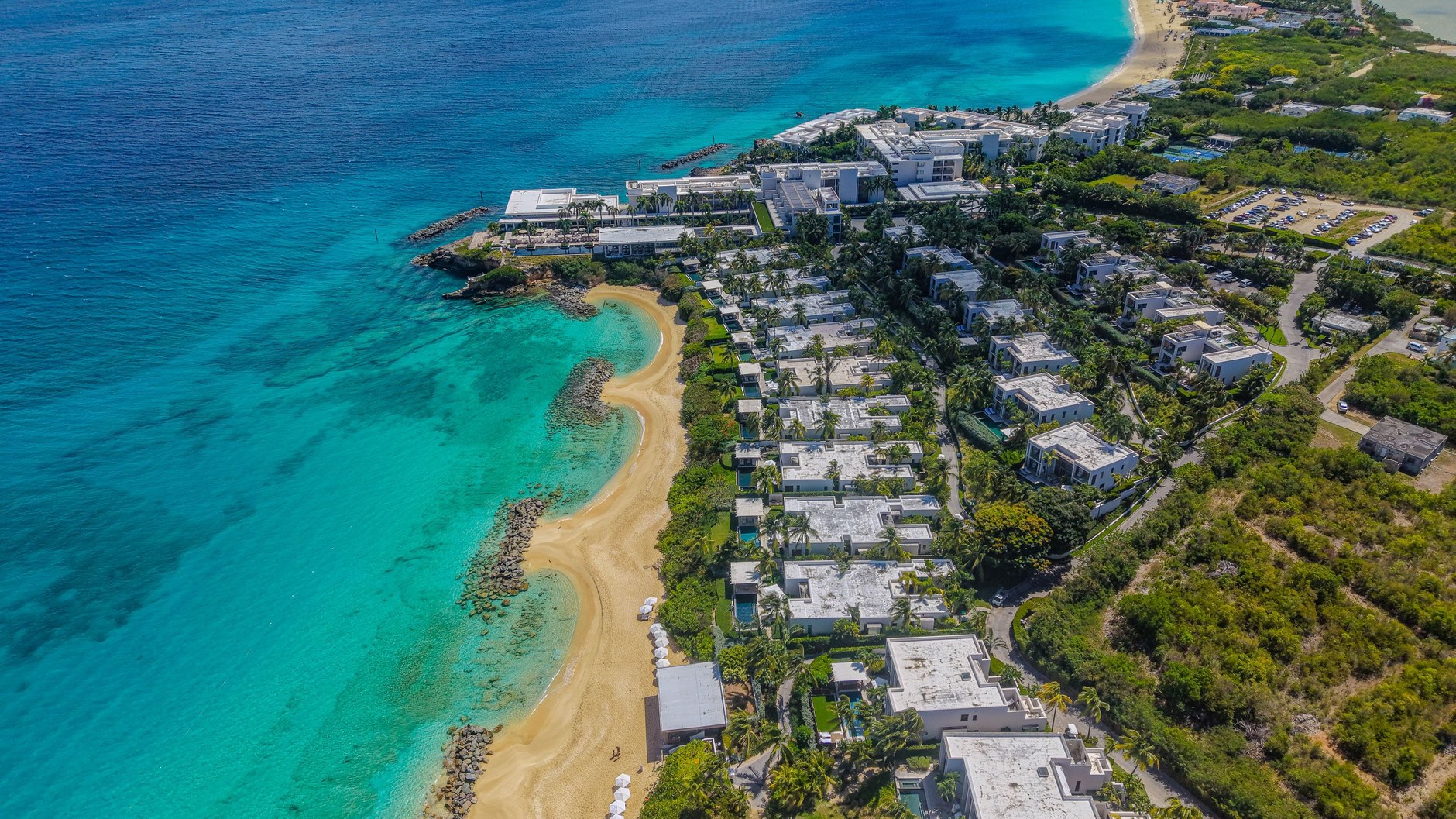 Long sweeping crescent of soft white sand and calm aquamarine sea in Anguilla