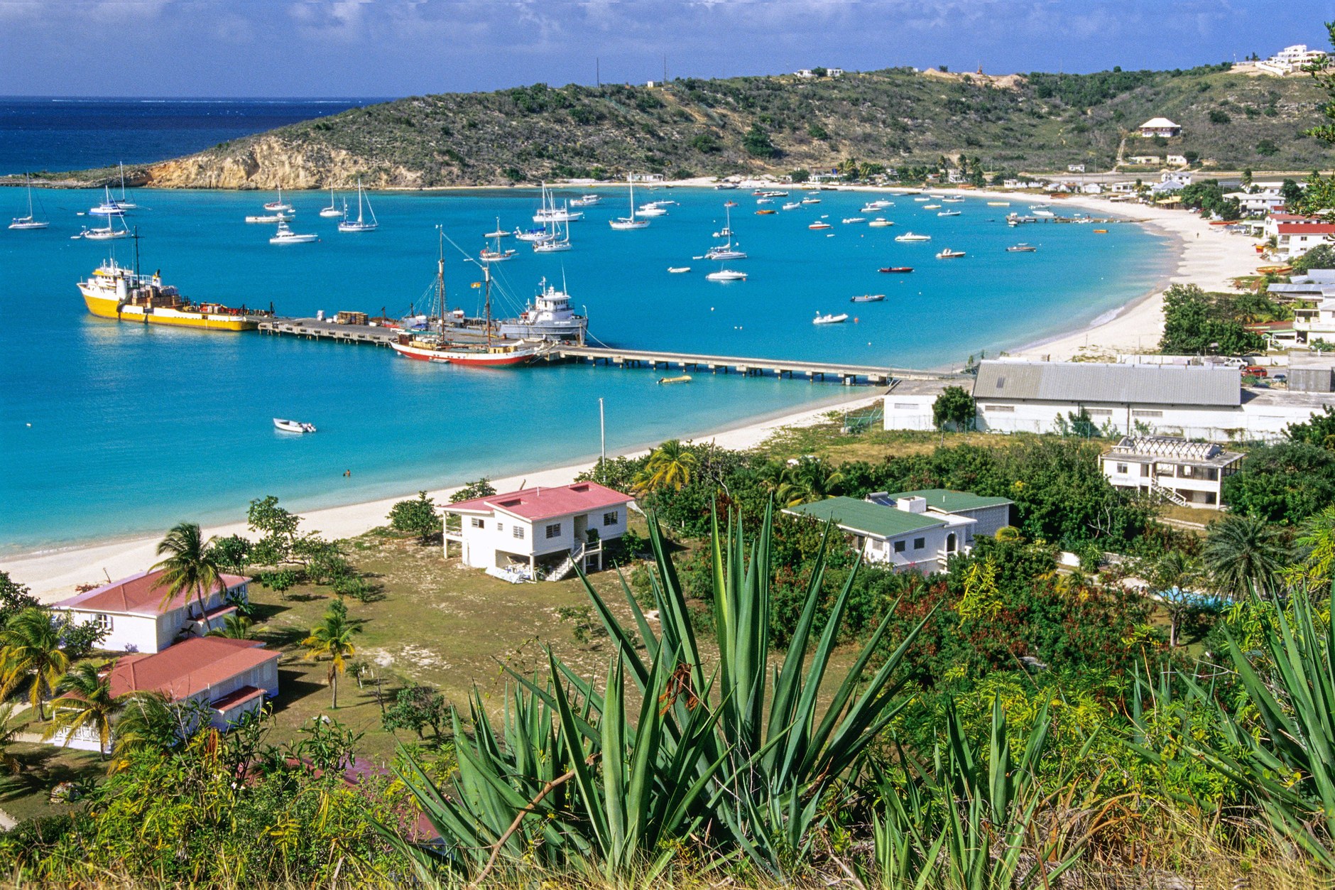 Aerial view of Sandy Ground Bay with sailing boats anchored between Road Salt Pond and the Caribbean Sea