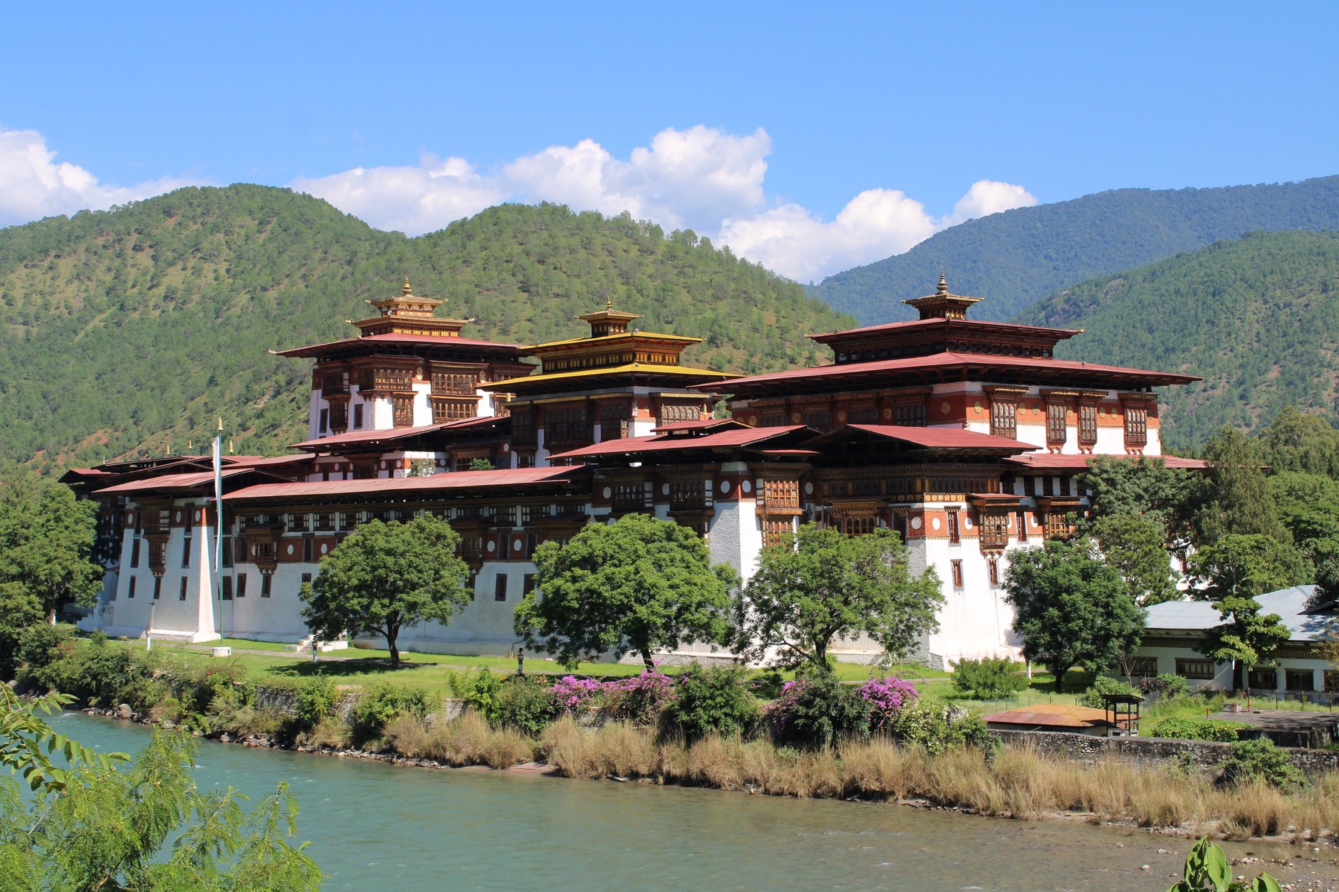 Intricately carved wooden windows and towering whitewashed stone walls of the Punakha Dzong fortress palace