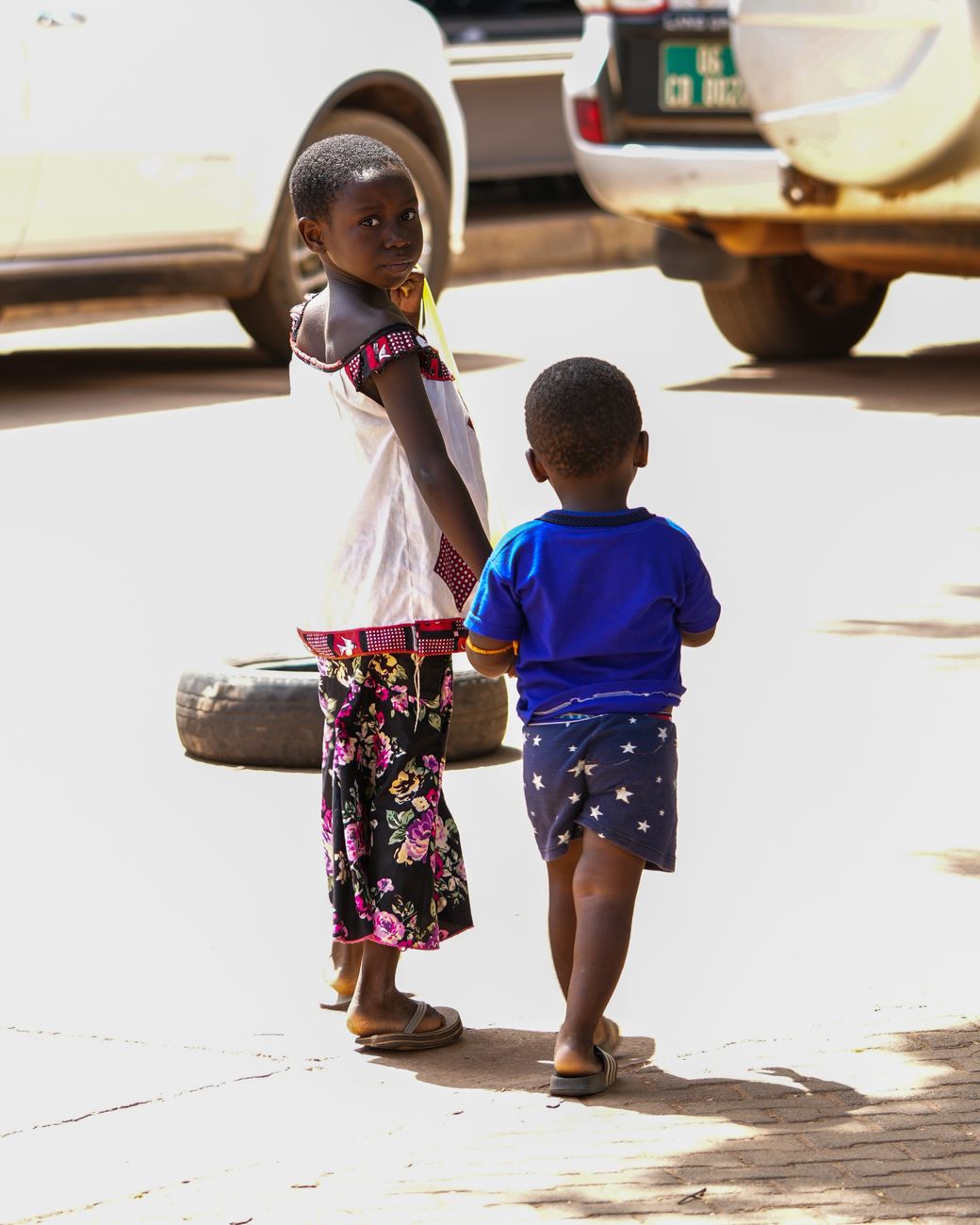 Urban street scene in Ouagadougou showing local pedestrians and daily life under Sahelian sunlight