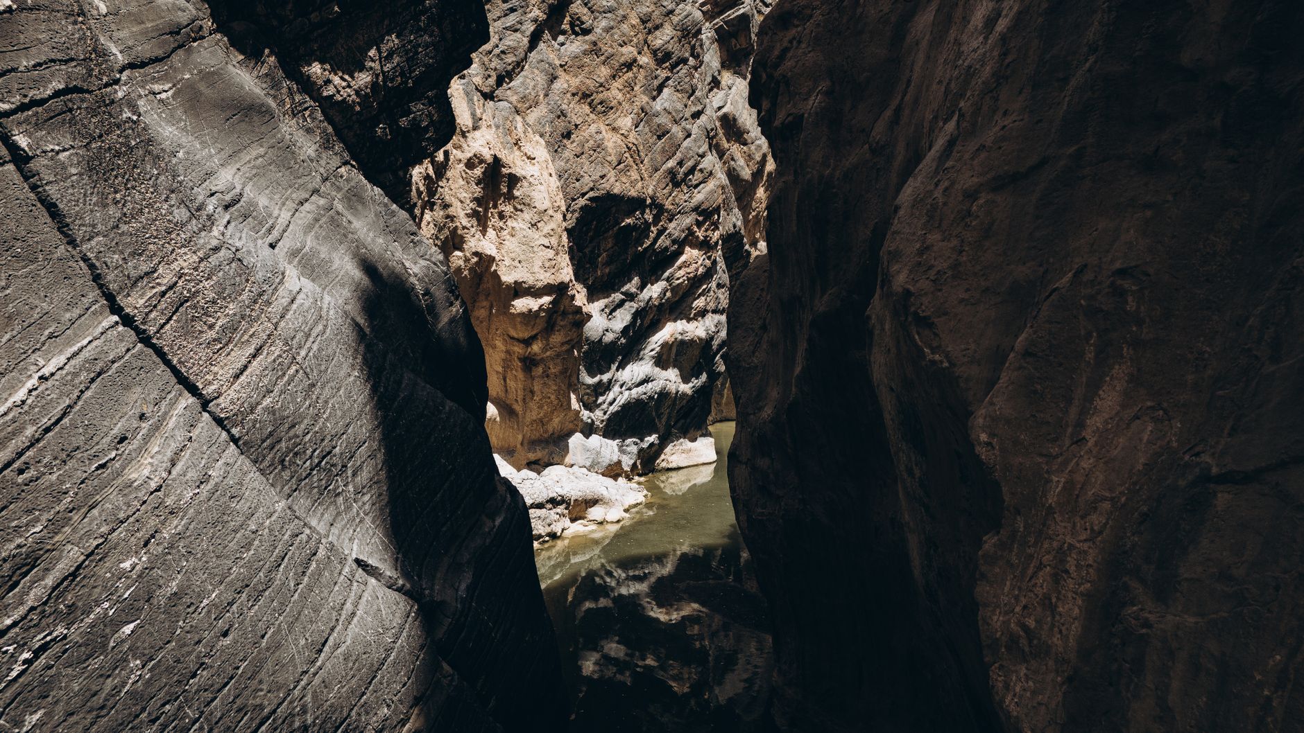 Deep sandstone canyon gorge with natural water reservoir at Guelta d'Archei in the Ennedi Plateau of northeastern Chad