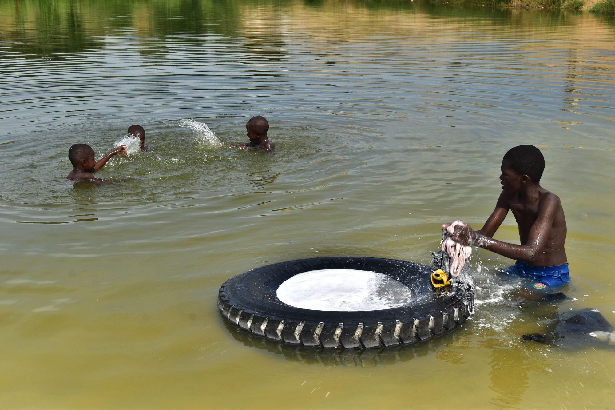 Freshwater lake scene in rural Republic of the Congo with local villagers engaged in daily life