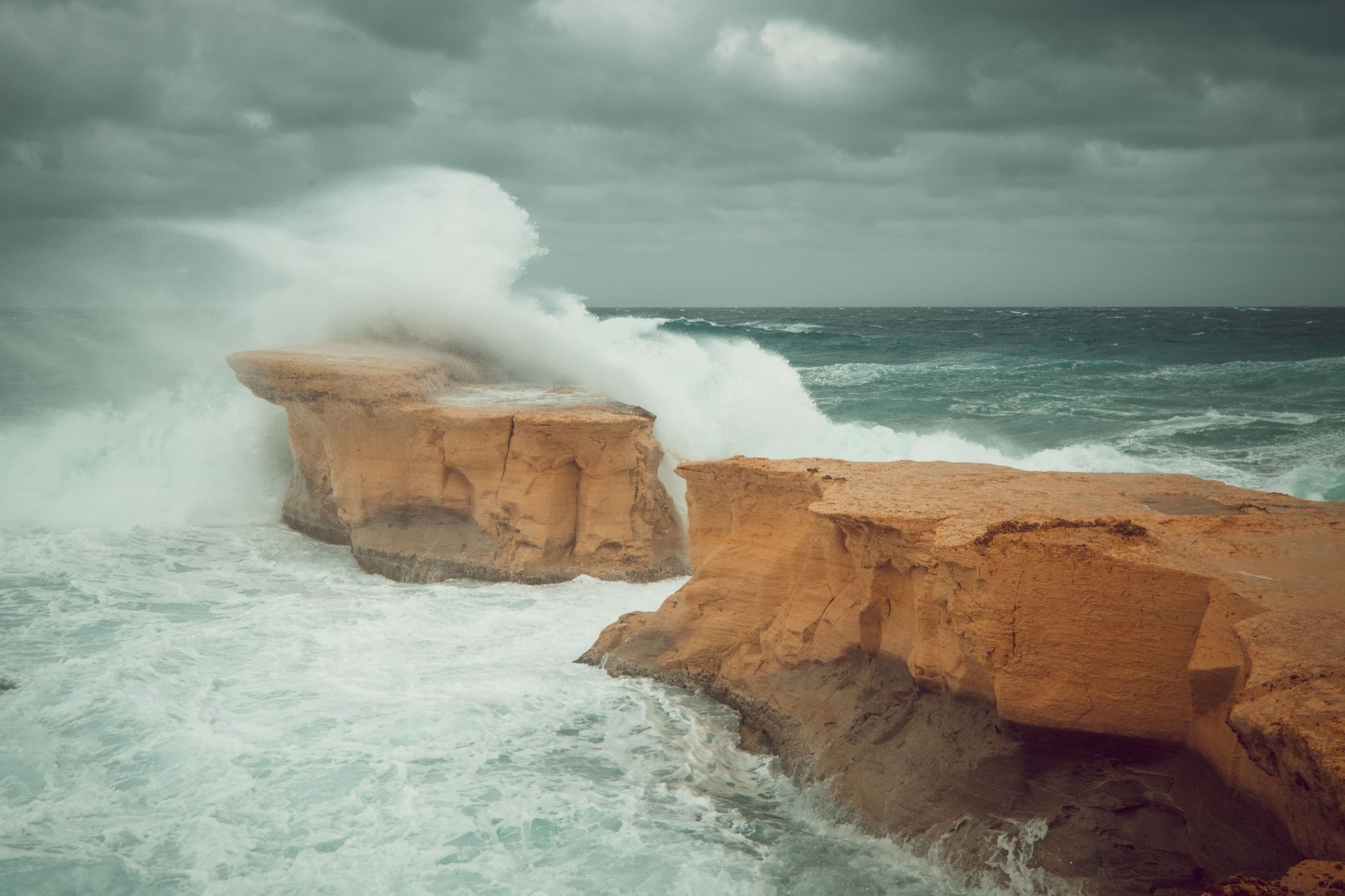 Ocean swells slamming into the rugged limestone bluffs of Shete Boka National Park