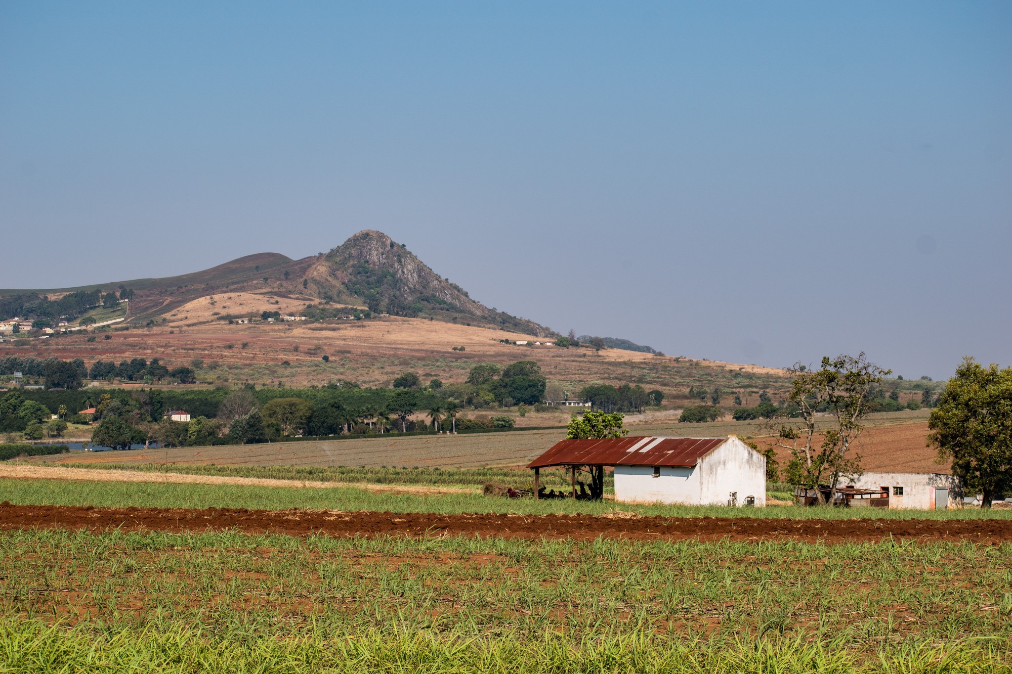 Rural African farmland with mountain ridges on the horizon in Manzini Eswatini
