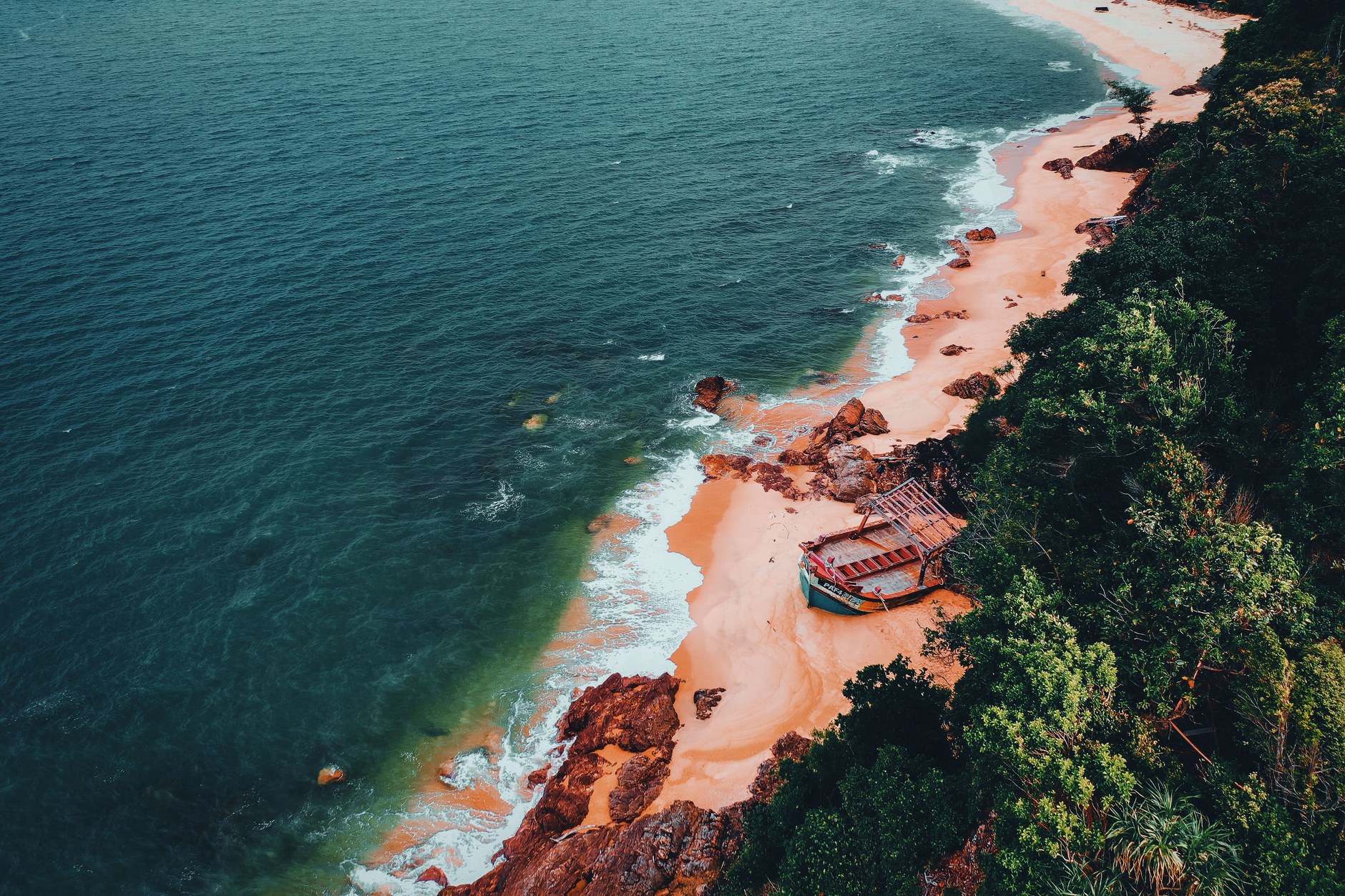 Pristine white sand and lush coastal forest at Ritidian Point National Wildlife Refuge