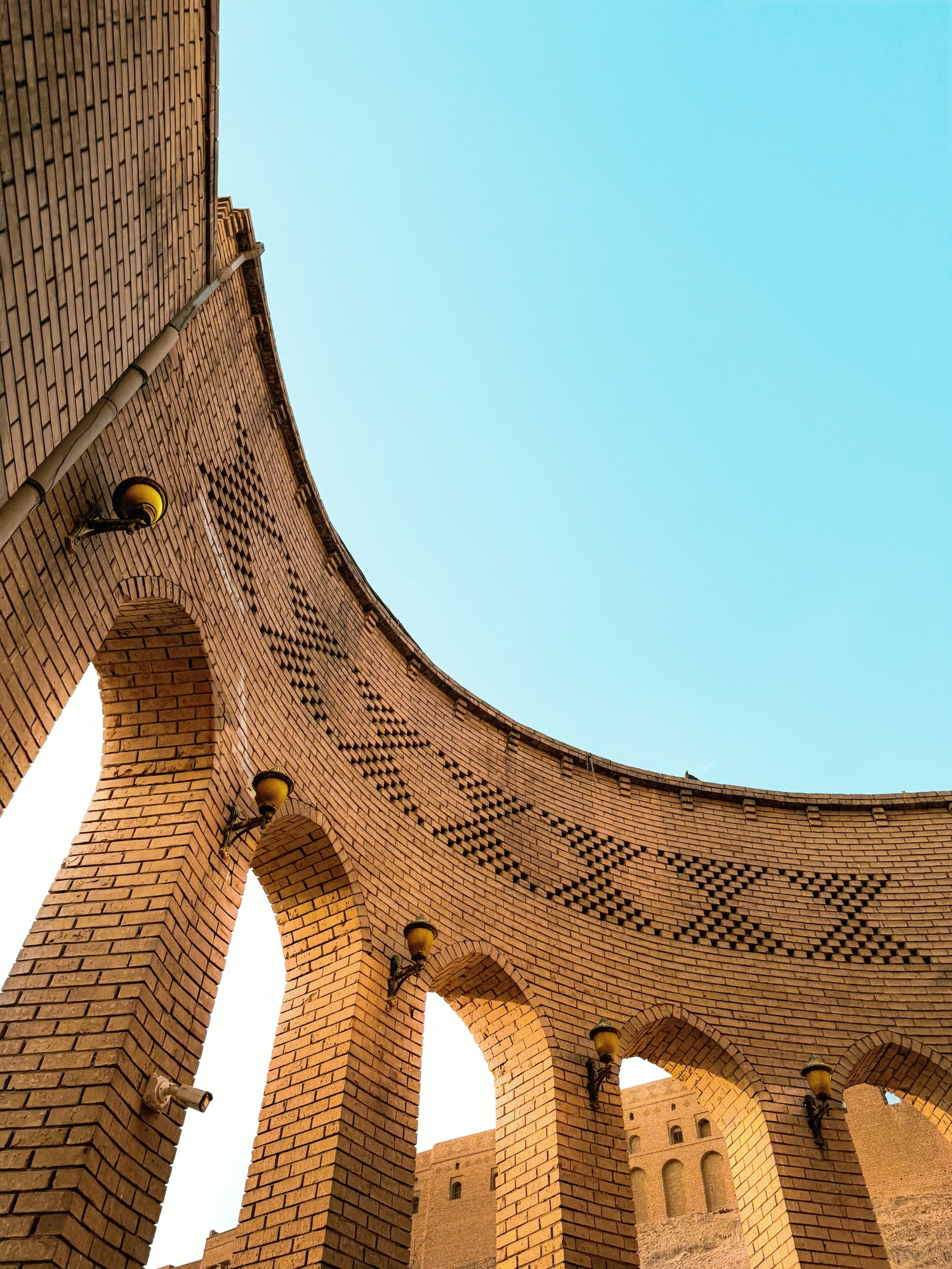 Intricate brickwork arches and fortified perimeter walls of the ancient Erbil Citadel in Iraqi Kurdistan