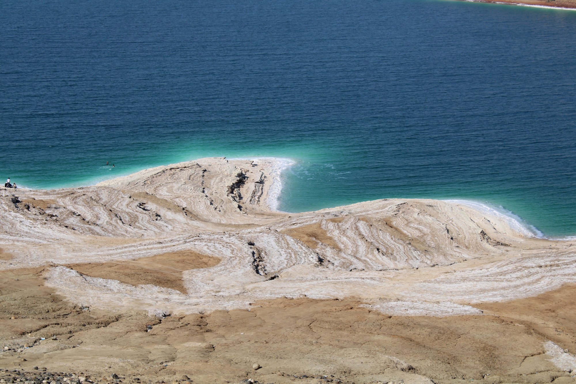 Aerial view of white crystalline salt formations along turquoise waters of the Dead Sea