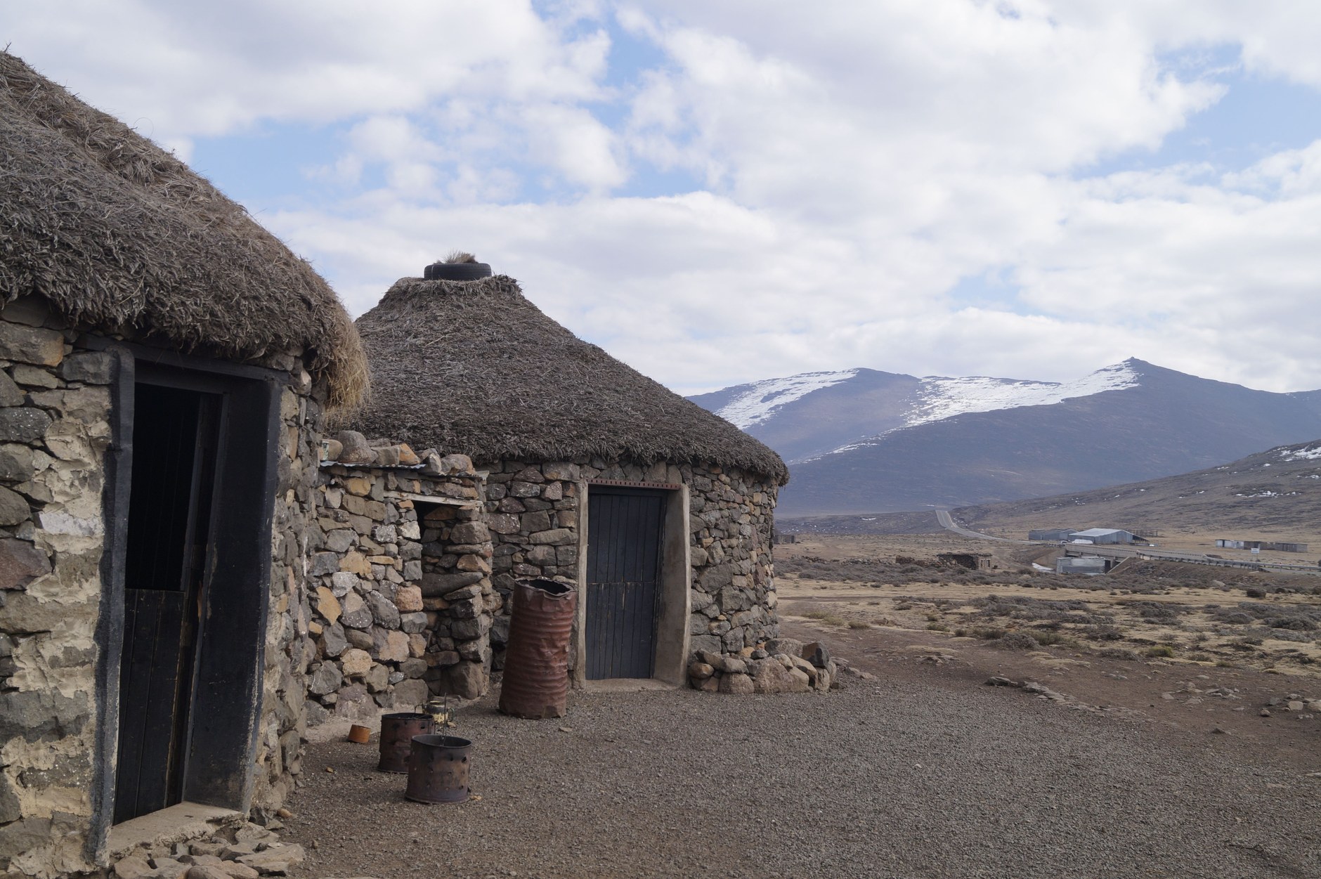 Traditional stone roundavels with conical thatched roofs in a remote highland Basotho village