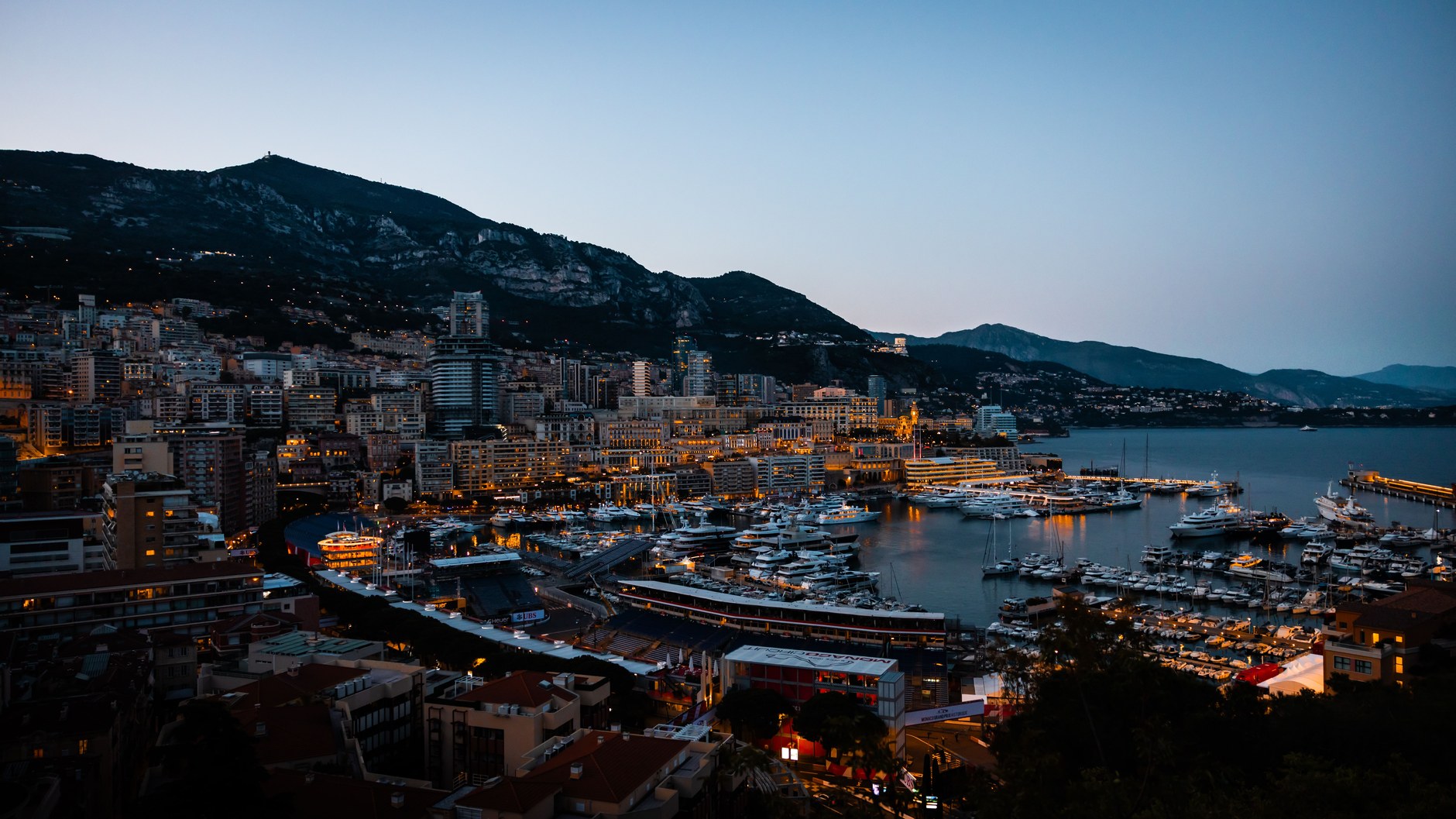 Dusk settles over the illuminated high-rises and harbor of Monte Carlo