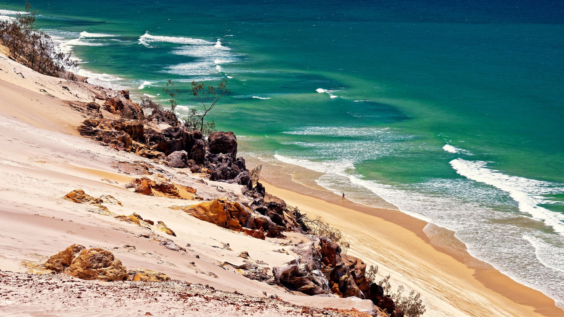 Towering coastal sand dunes plunging into the clear waters of Bazaruto Island