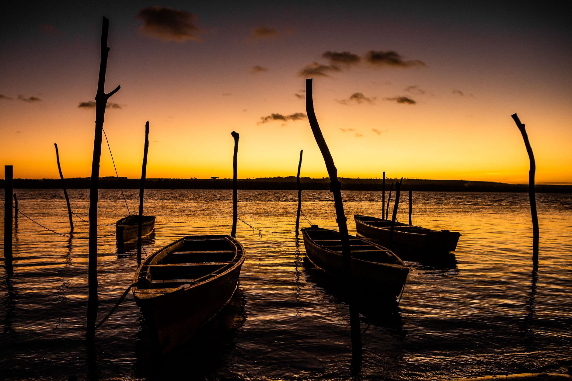Evening twilight illuminating wooden sailing boats anchored off the southern coast