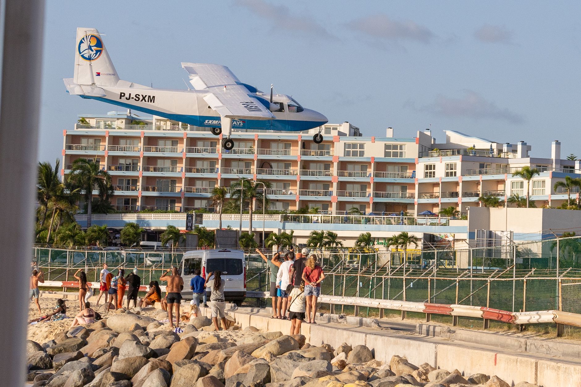 Commercial passenger jet approaching at low altitude over Maho Beach toward Princess Juliana International Airport in Sint Maarten