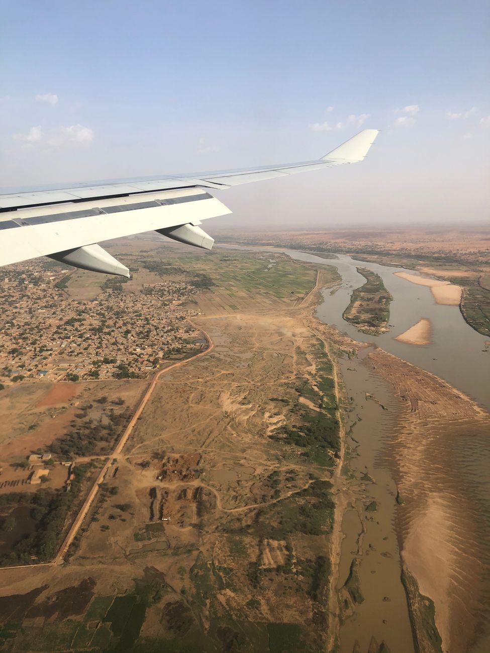 The wide green bend of the Niger River flowing past the capital city of Niamey