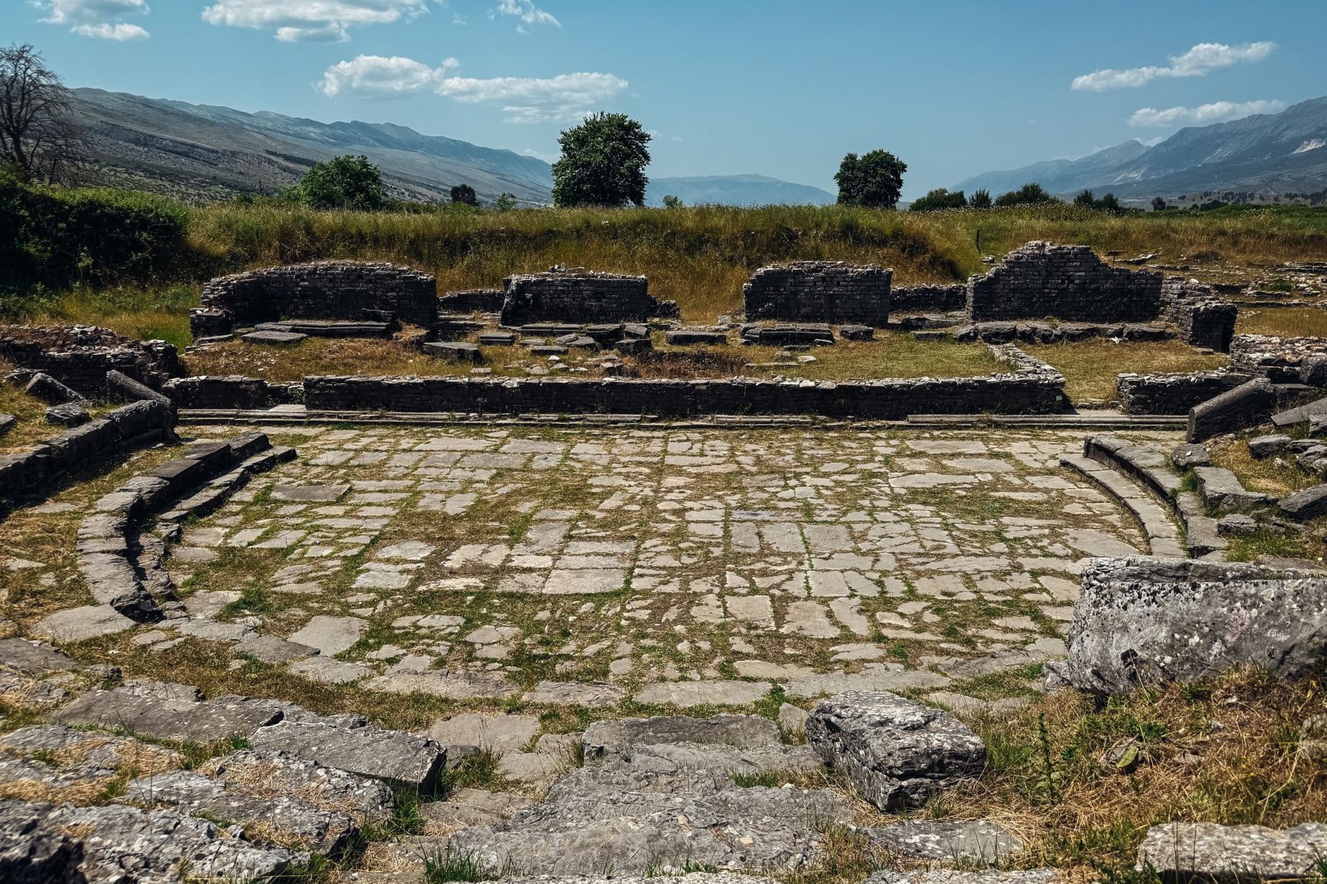 Ancient Greco-Roman amphitheater surrounded by lush Mediterranean oak trees at Butrint National Park Albania