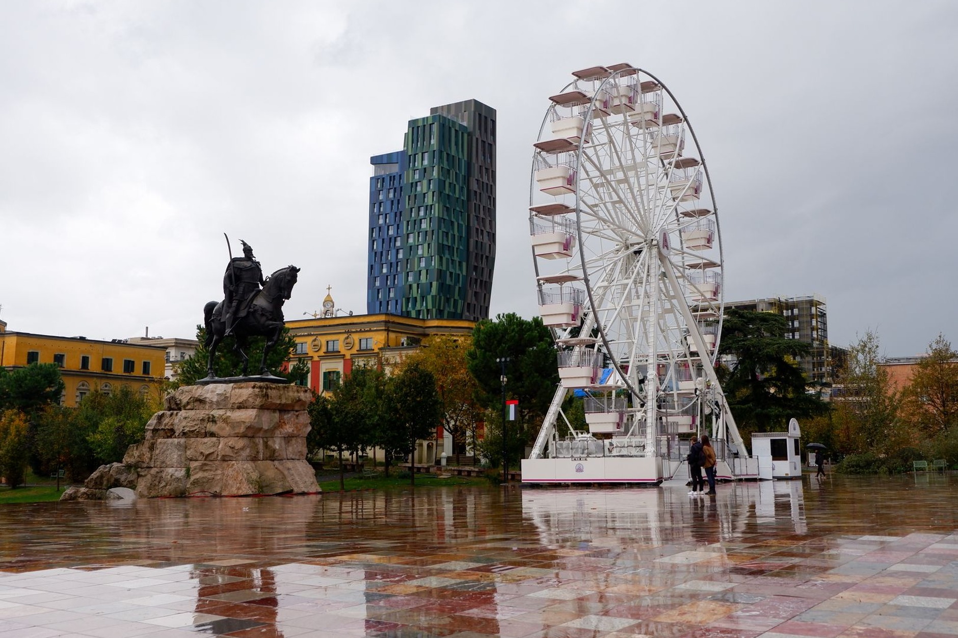 Skanderbeg Square in central Tirana featuring wide open pedestrian plaza and pastel Italianate government buildings