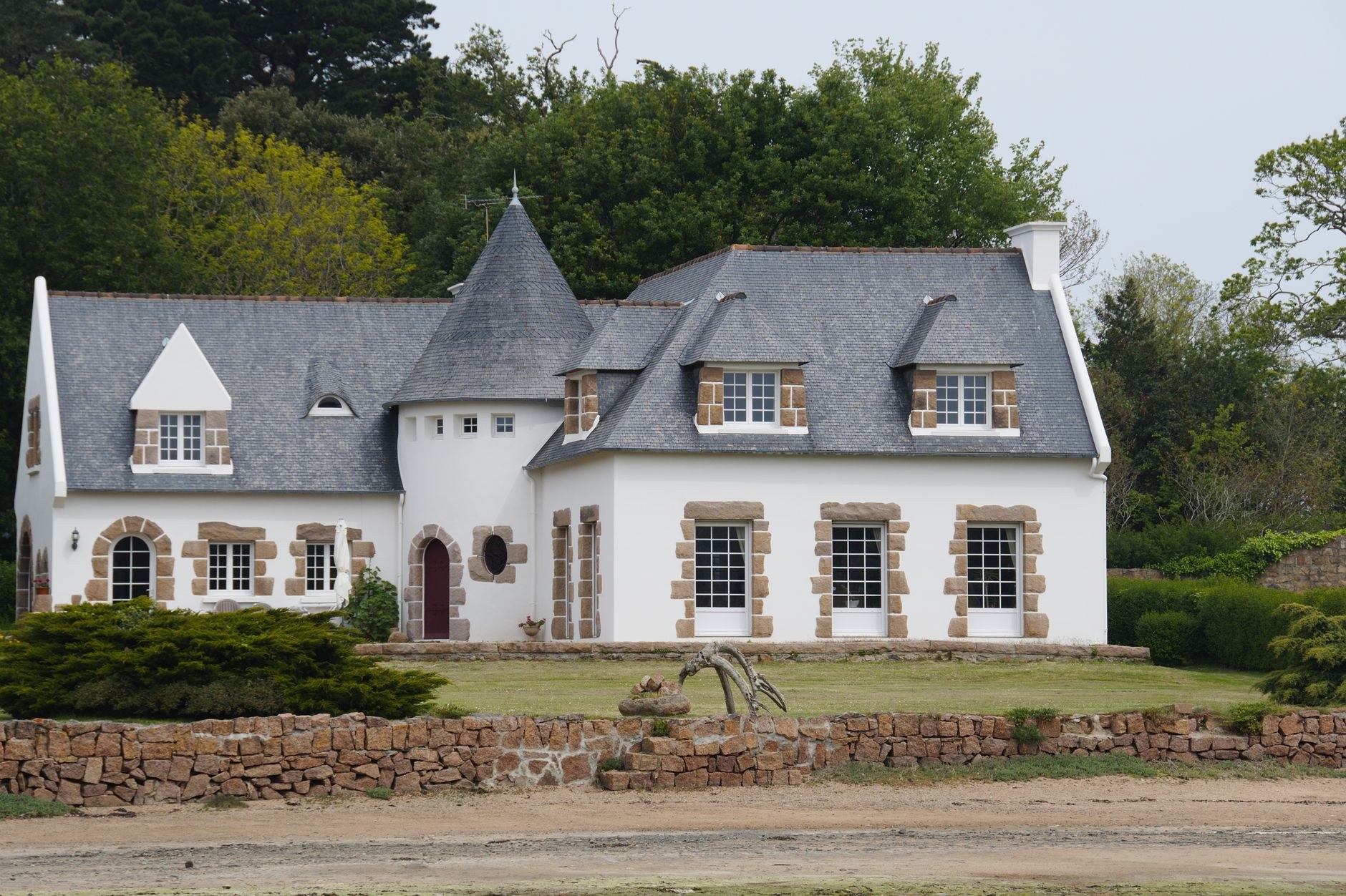 A 16th-century rustic stone manor house with dove-cote tower and slate roof in the historic quarter