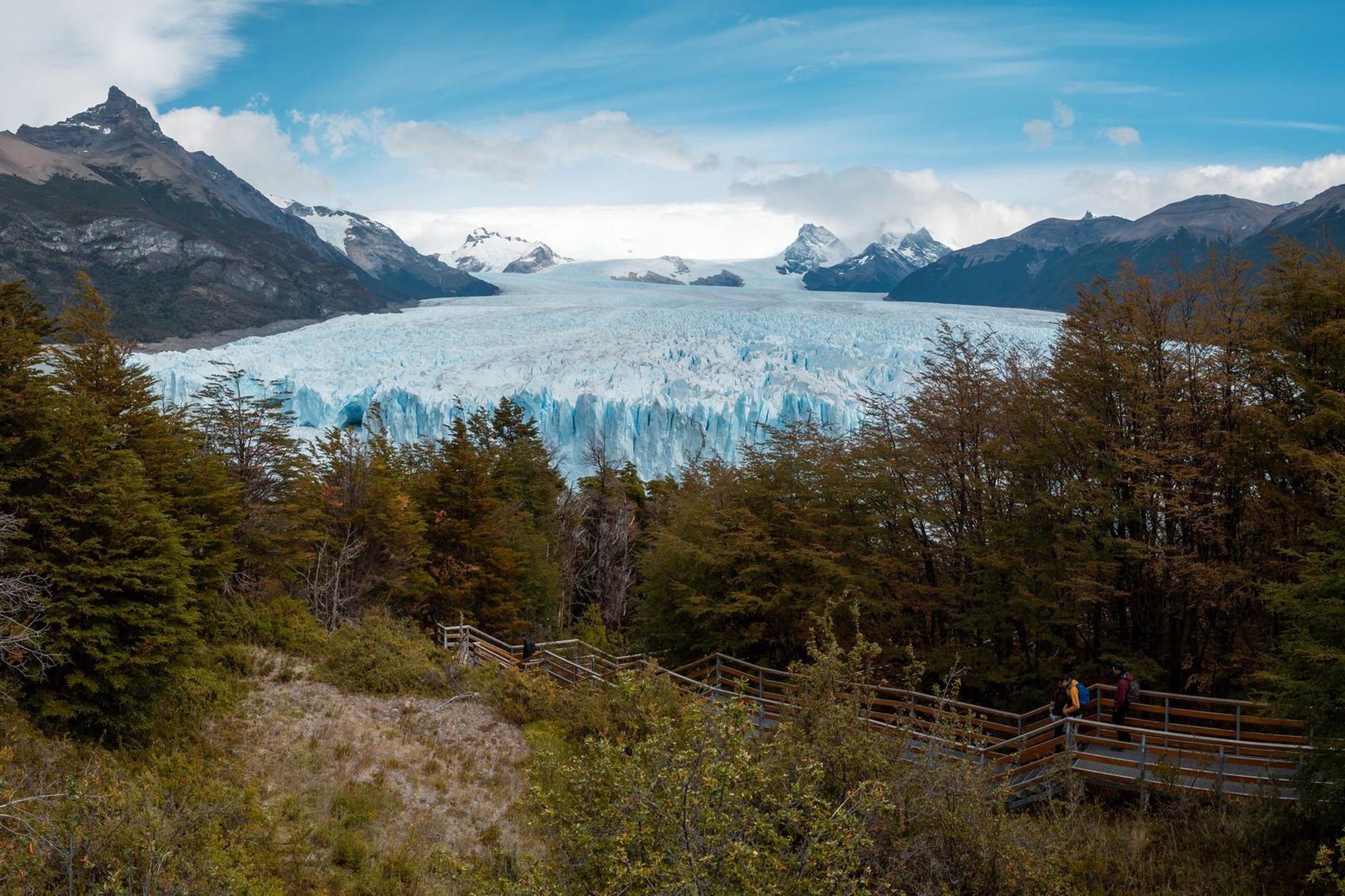 Wooden boardwalk viewing platforms looking out toward the massive terminus ice wall of the Perito Moreno Glacier