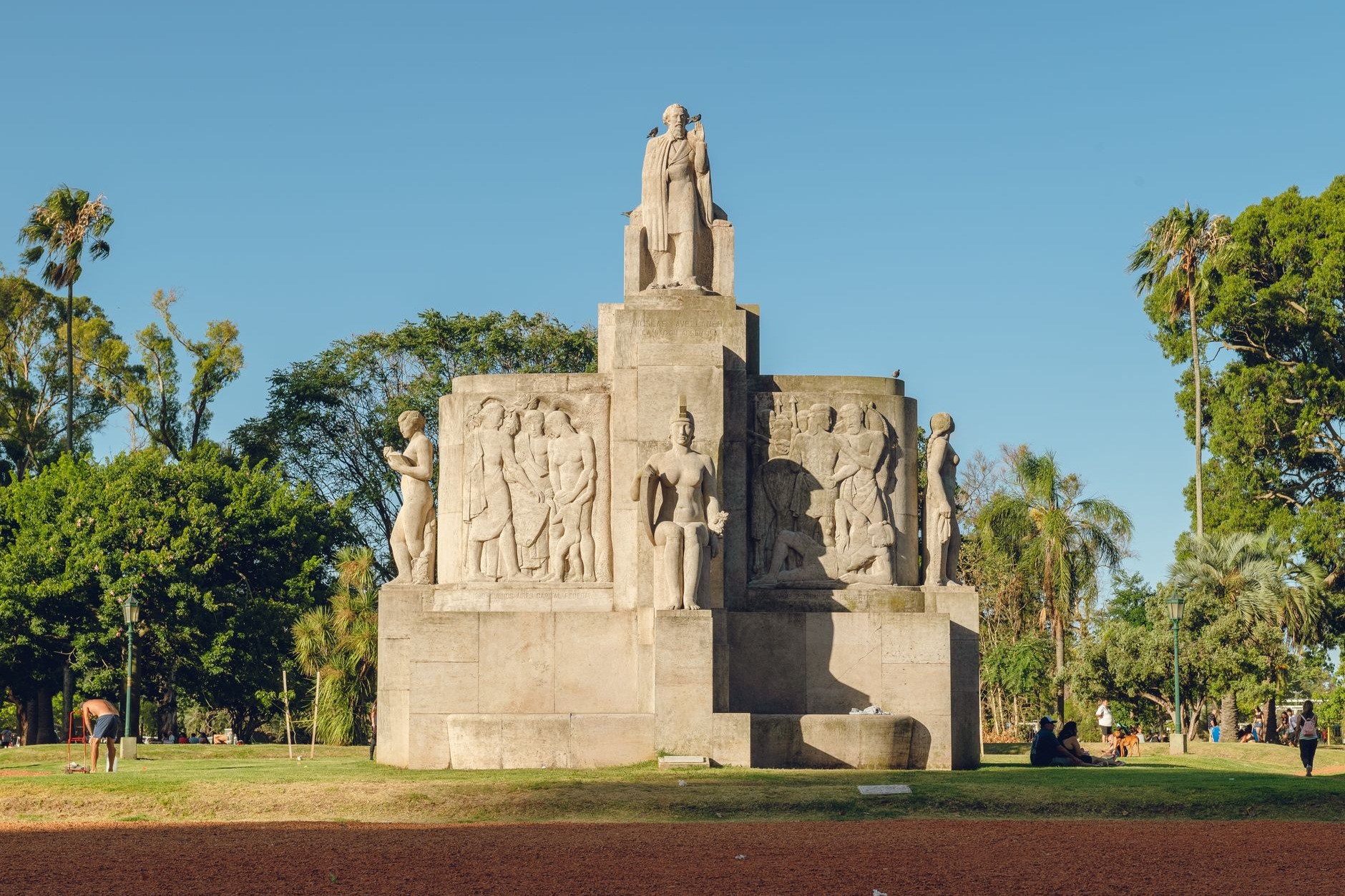 Elaborate neoclassical marble mausoleums and sculpted statues lining narrow pedestrian walkways in Recoleta Cemetery