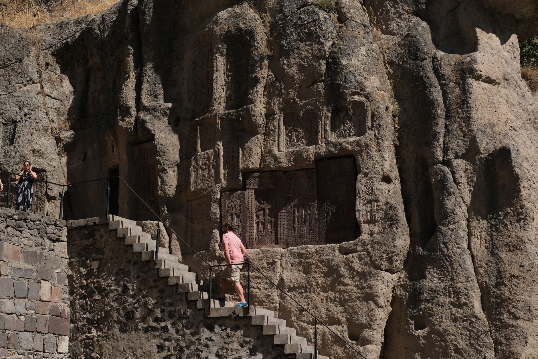 Medieval stone towers and rock-carved chapels of Geghard Monastery embedded into the towering cliffs of the upper Azat Valley