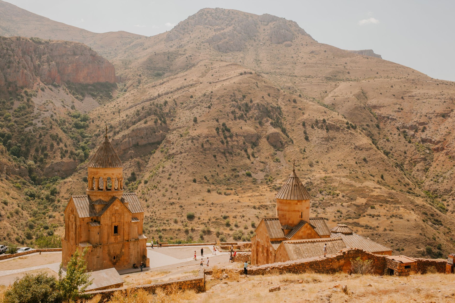 Thirteenth-century two-story Surb Astvatsatsin church at Noravank Monastery framed by towering vertical red limestone canyon cliffs
