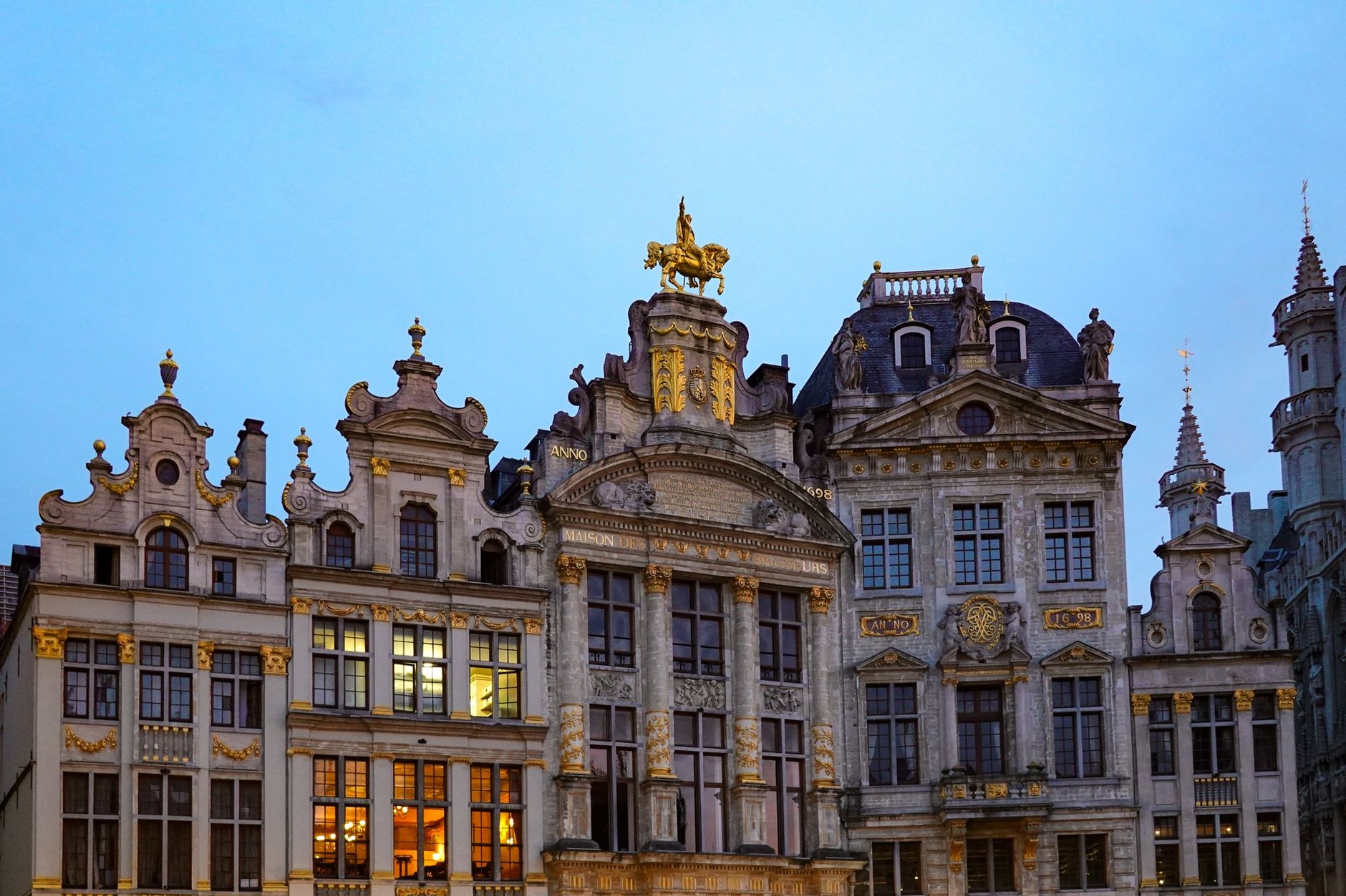Ornate gilded Baroque guildhalls and Gothic Town Hall surrounding the historic cobblestone Grand-Place in Brussels