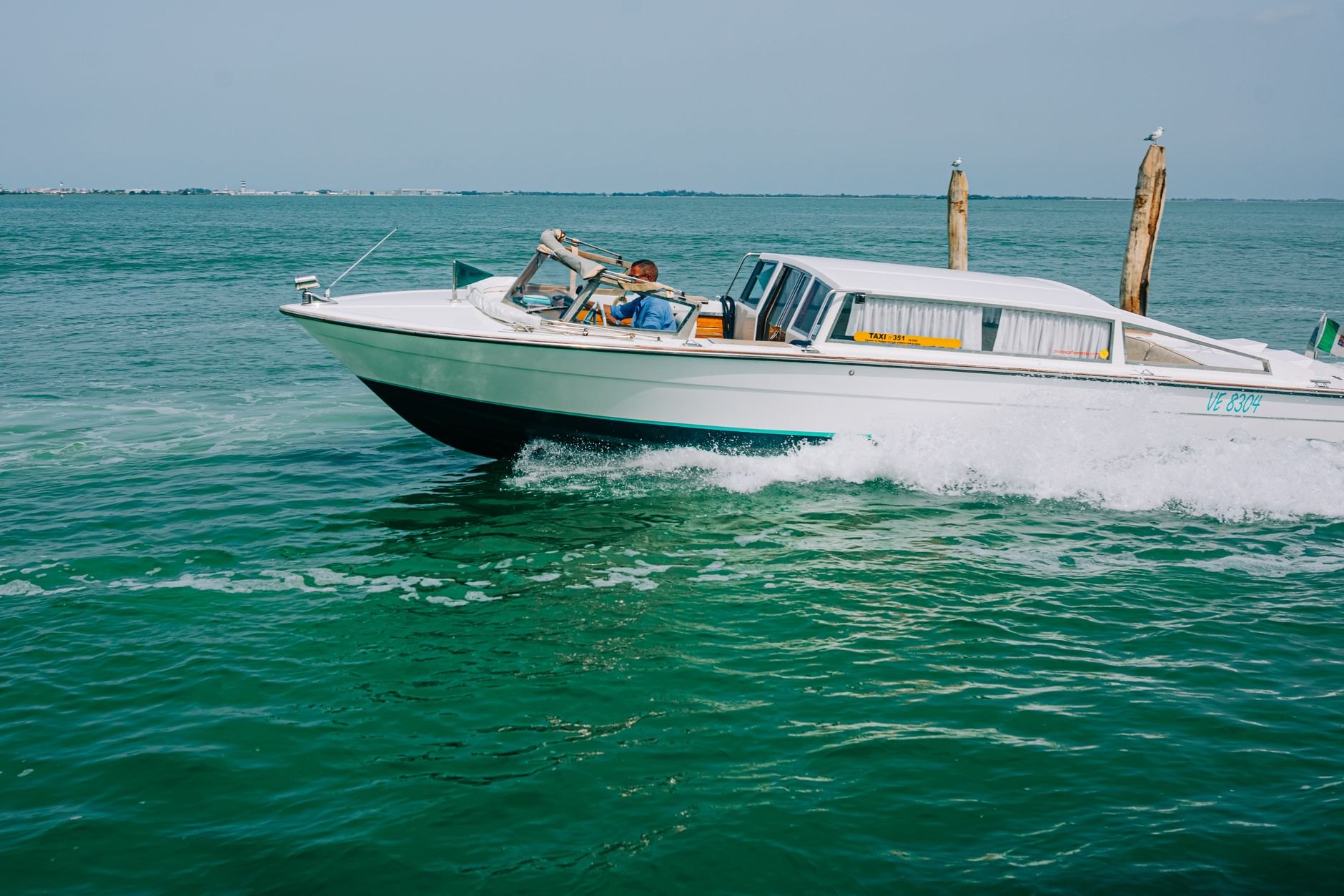Sleek high-speed passenger water taxi boat cruising across brilliant turquoise Caribbean sea waters