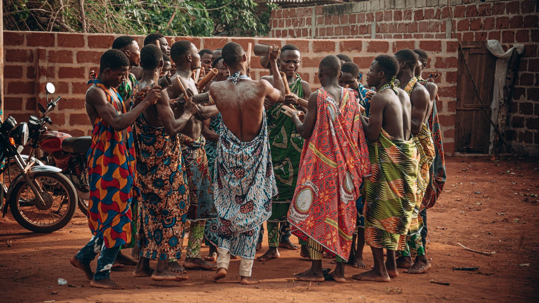 Participants in traditional ceremonial garments and beaded headwear during a cultural gathering in Benin