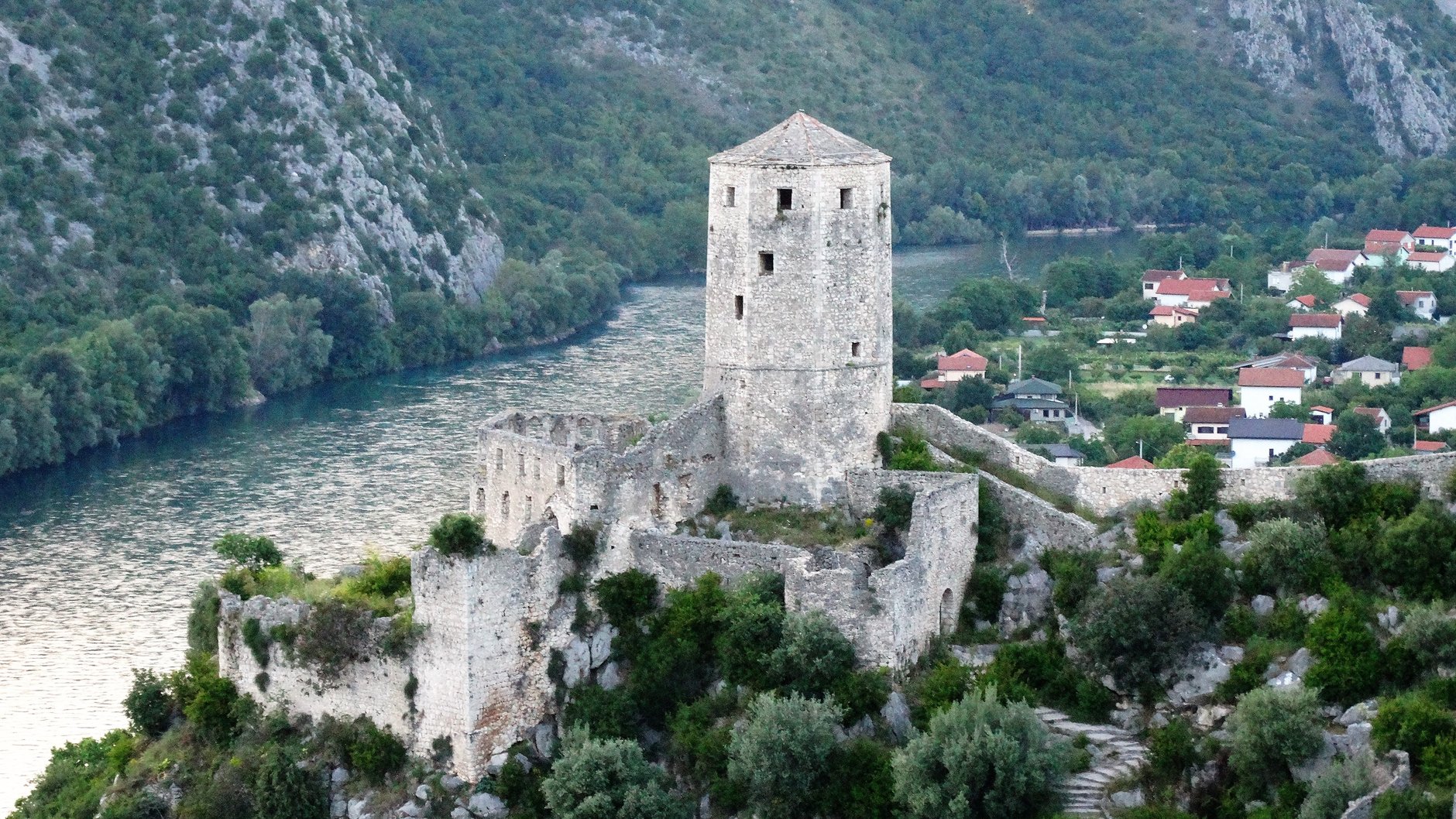 Steep hillside stone amphitheater and medieval fortress watchtower of Pocitelj overlooking the Neretva river valley