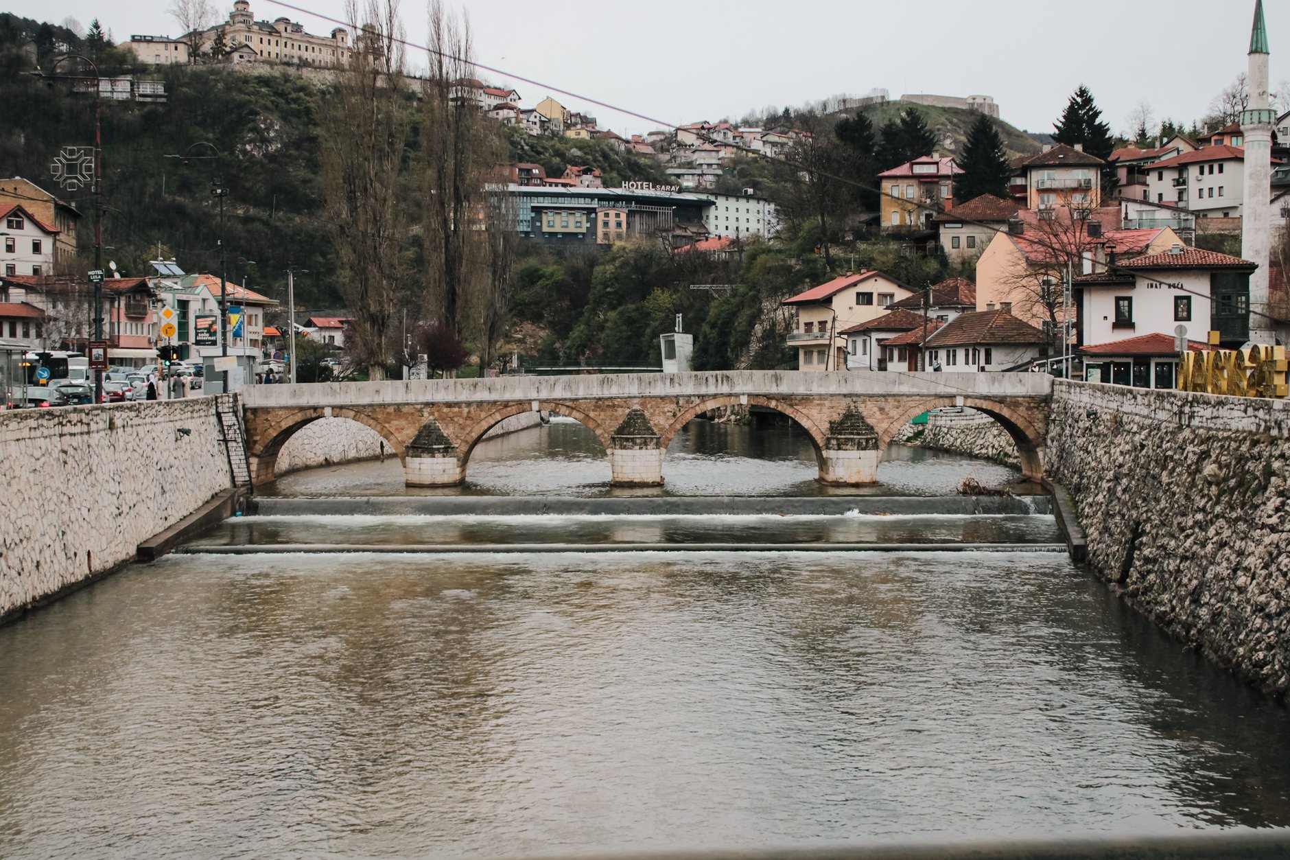 Four-arched historic stone Latin Bridge spanning the Miljacka River in downtown Sarajevo near the site of the 1914 assassination