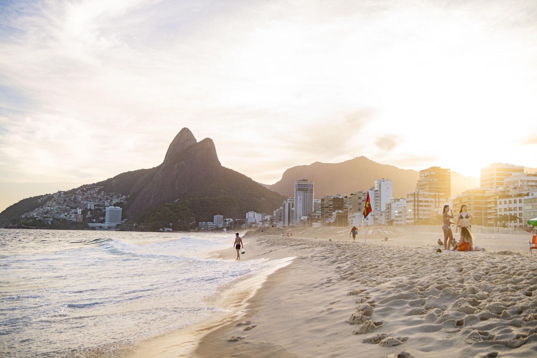 Ipanema beach promenade and breaking waves with Morro Dois Irmãos twin peaks in the background