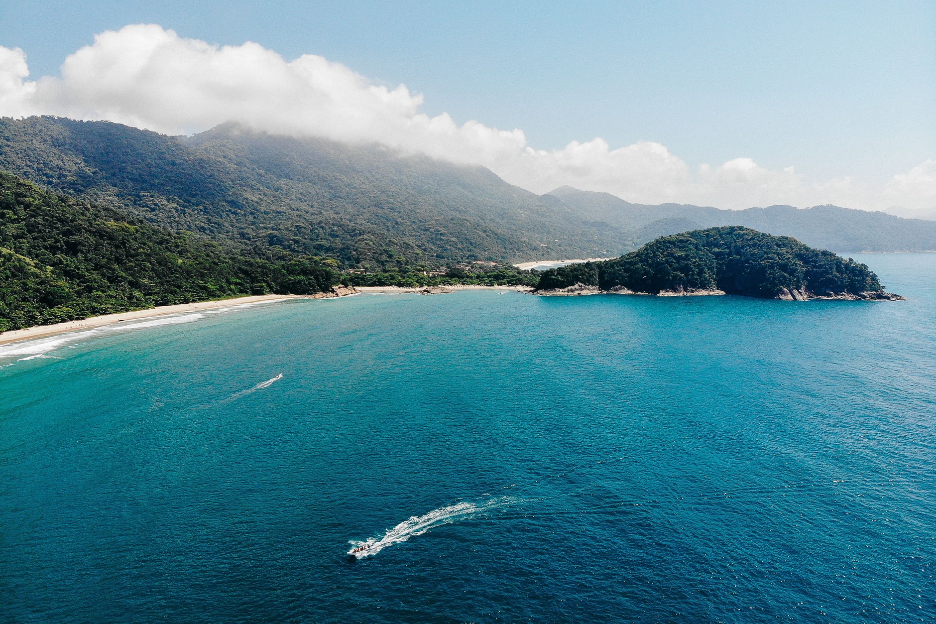 Untamed white sand and breaking surf at Lopes Mendes beach framed by Atlantic rainforest on Ilha Grande