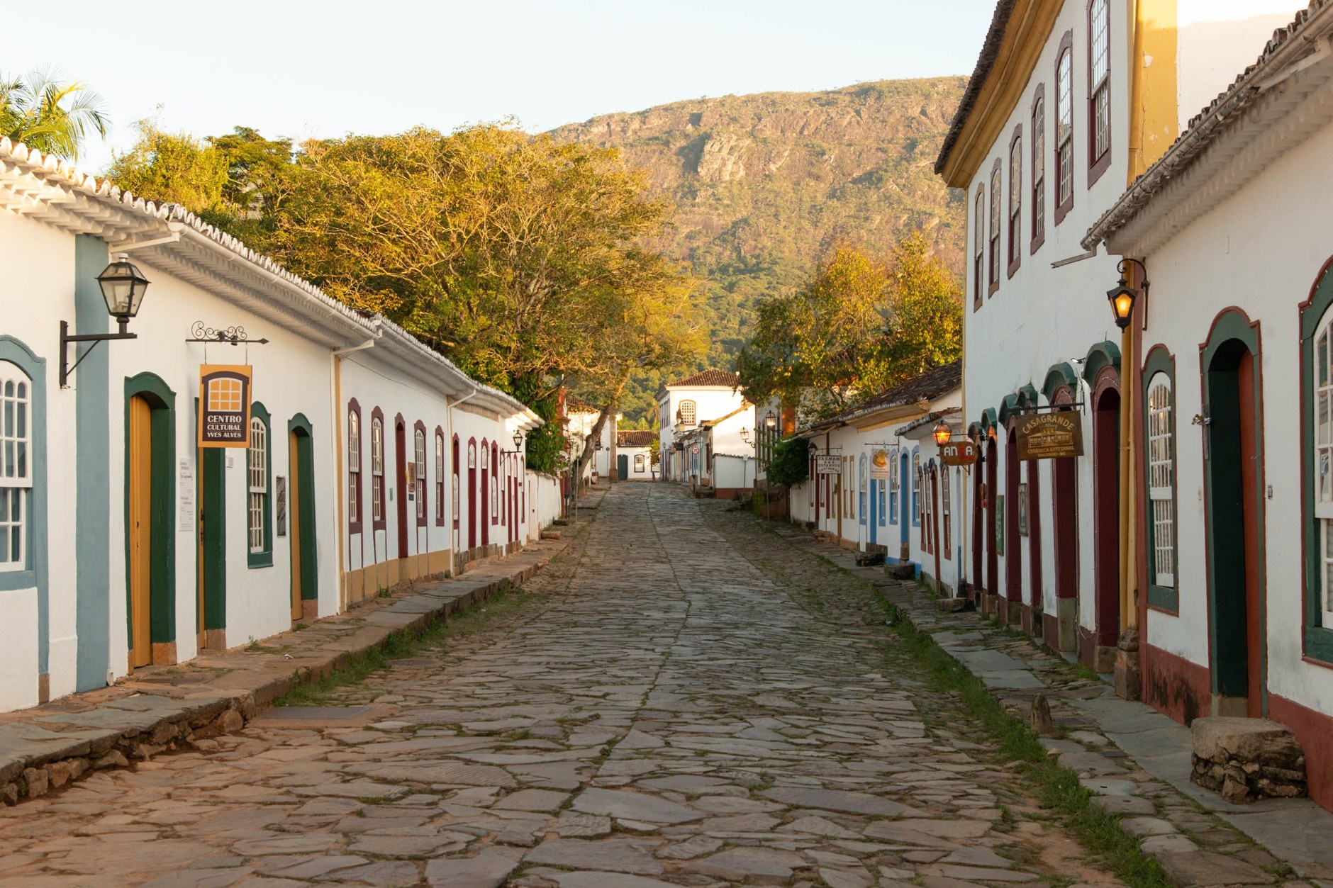 Whitewashed colonial buildings with brightly painted doorways on cobblestone streets in historic Paraty