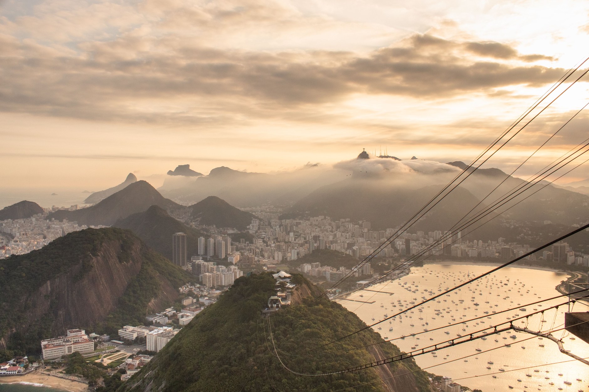 The Sugarloaf Mountain cable car ascending over Guanabara Bay at sunset in Rio de Janeiro