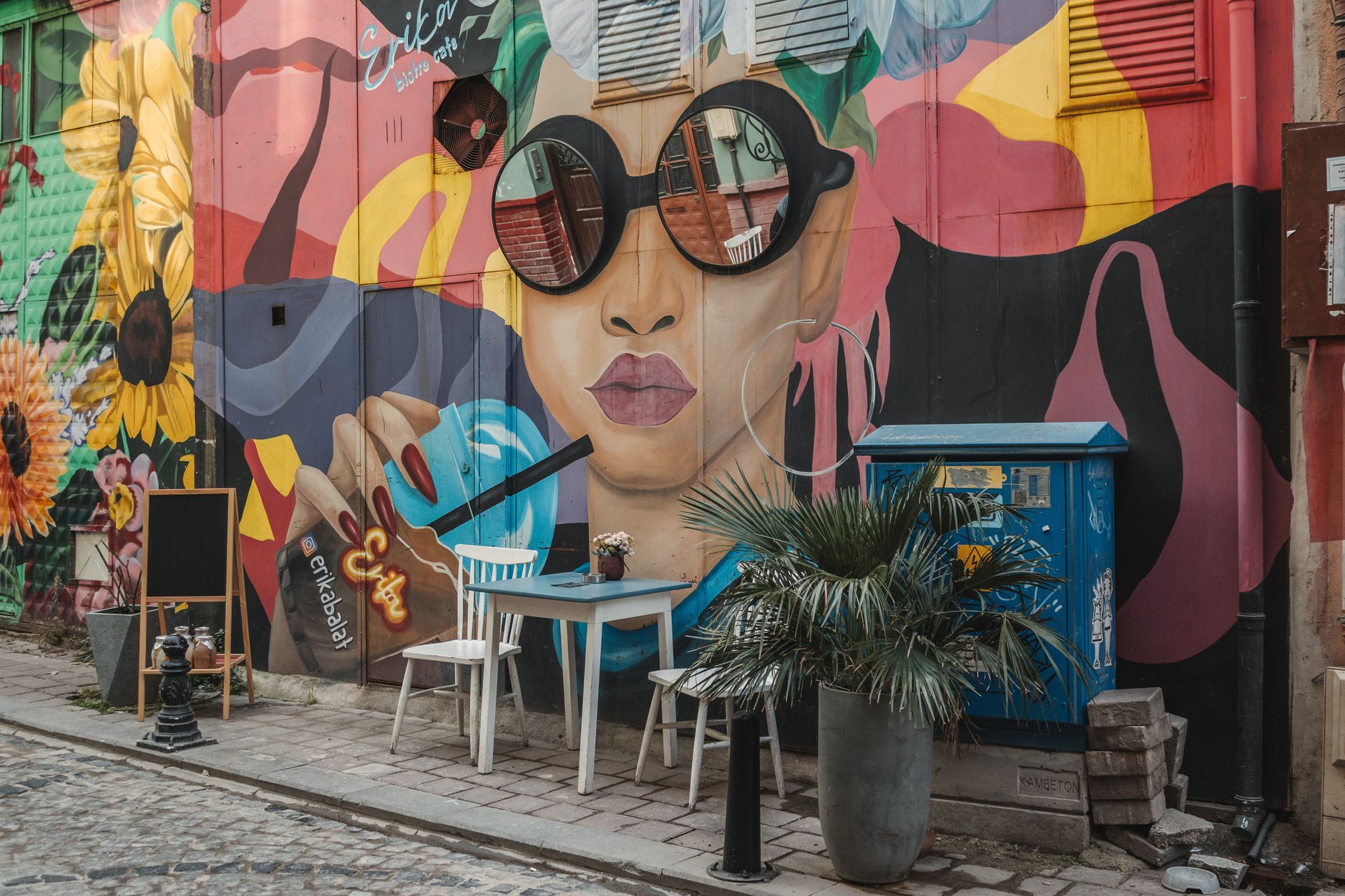Pedestrian alleyway in Kapana creative district of Plovdiv lined with outdoor artisan cafes and colorful overhead bunting