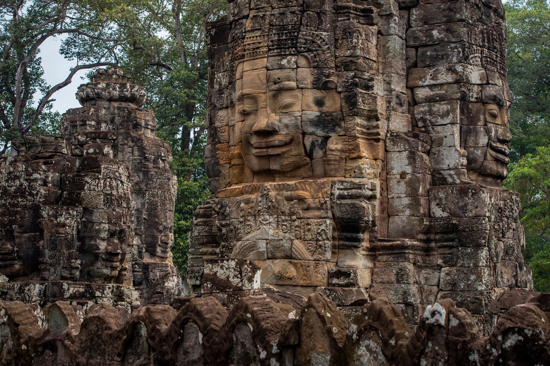 Serene smiling stone face towers of the 12th-century Bayon temple in Angkor Thom