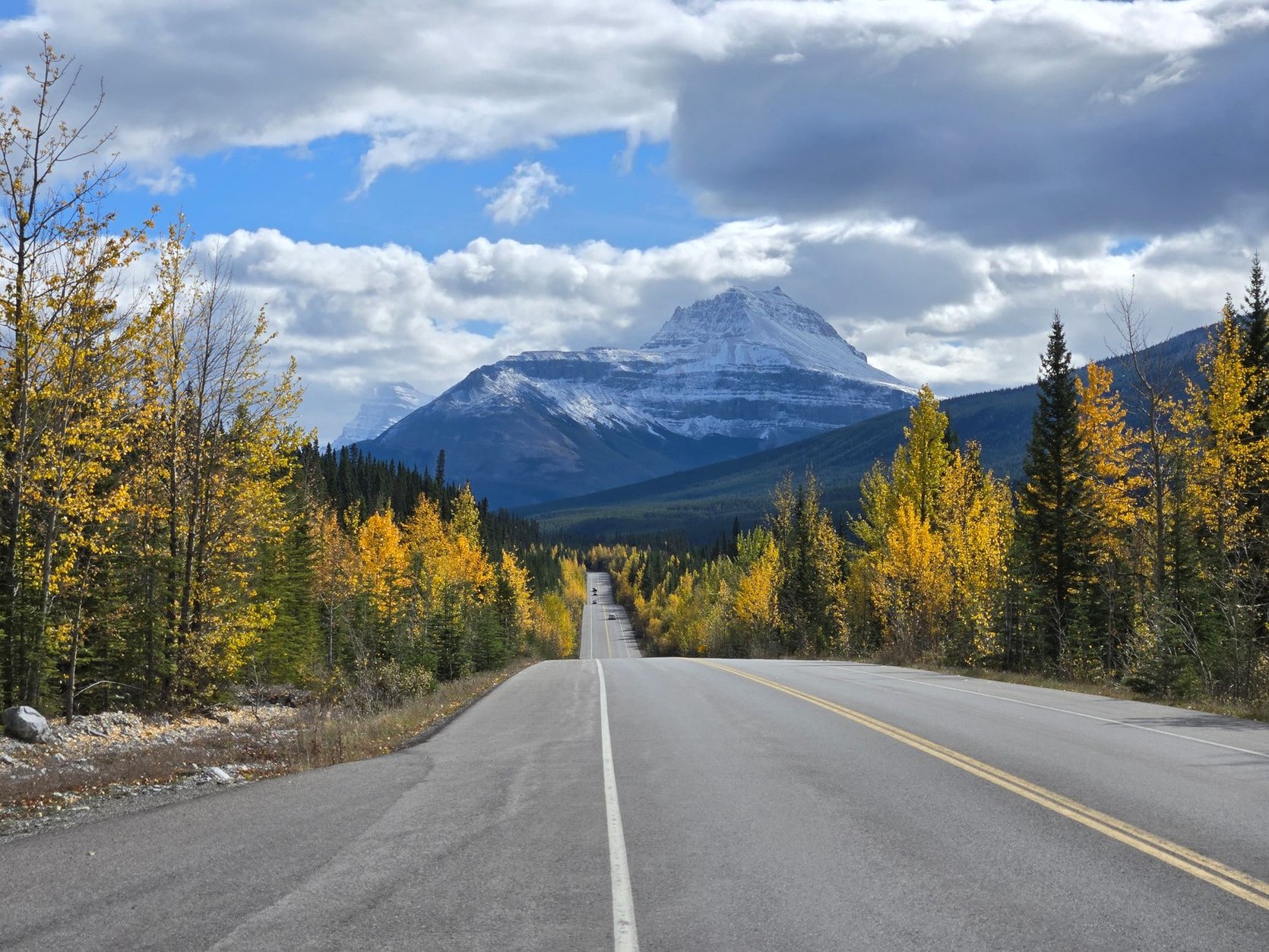 Highway 93 Icefields Parkway cutting through towering Canadian Rocky mountains