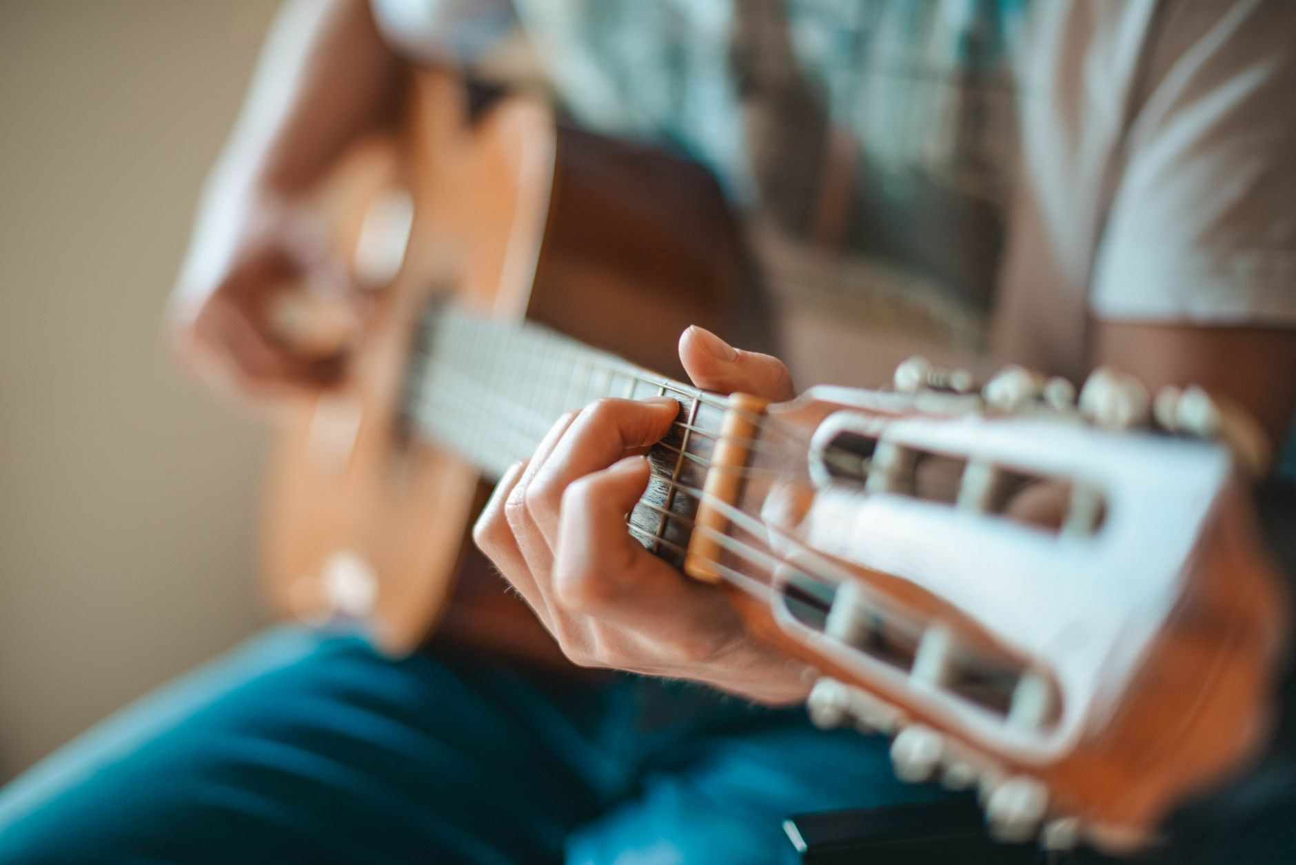 Musician playing an acoustic guitar, demonstrating the fingerpicking style of traditional Cape Verdean morna music