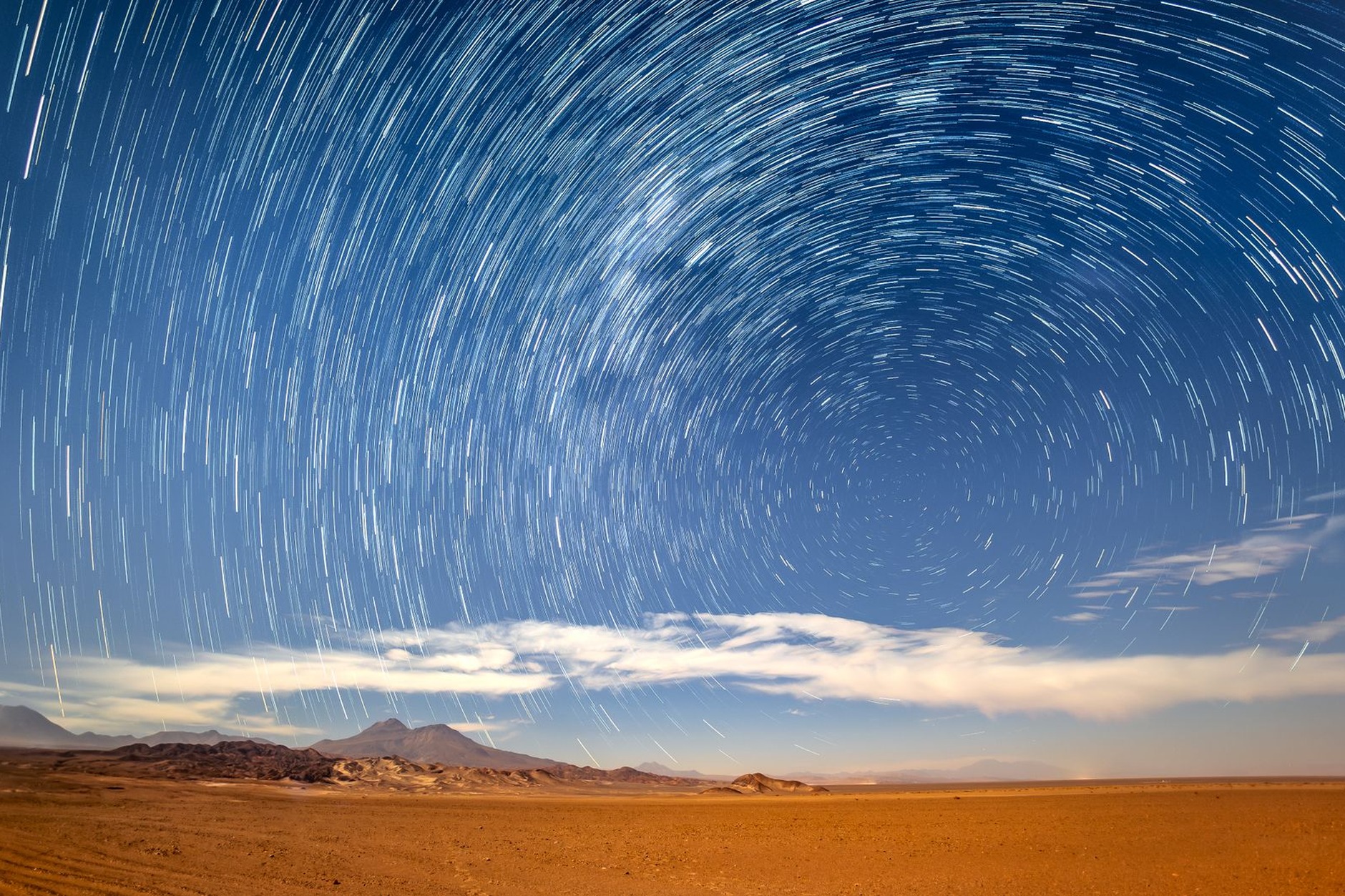 Brilliant Milky Way galaxy arching across a pitch-black starry sky above the Atacama Desert desert horizon