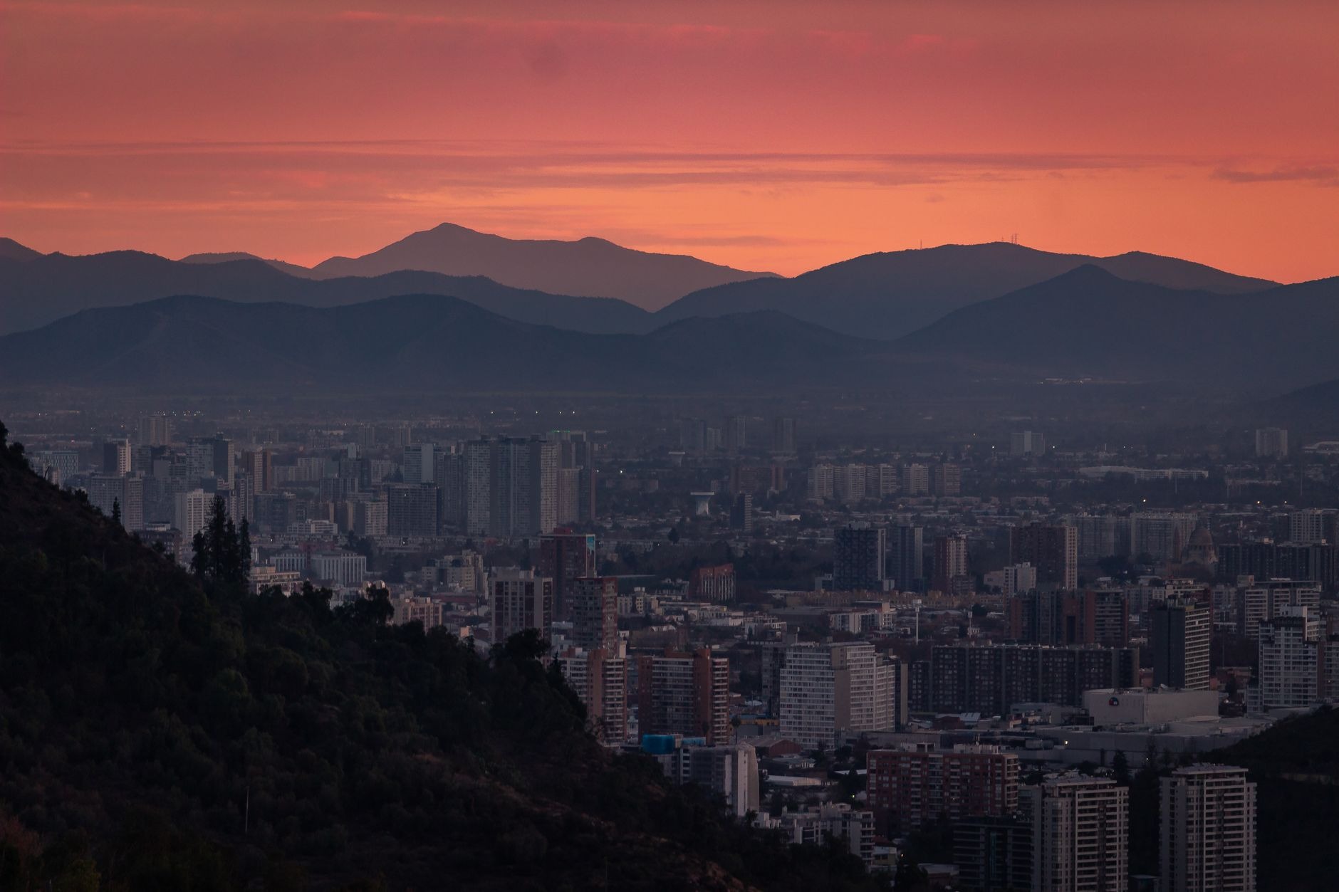 Modern glass skyscrapers of Santiago Chile skyline framed by the towering snowcapped Andes mountains