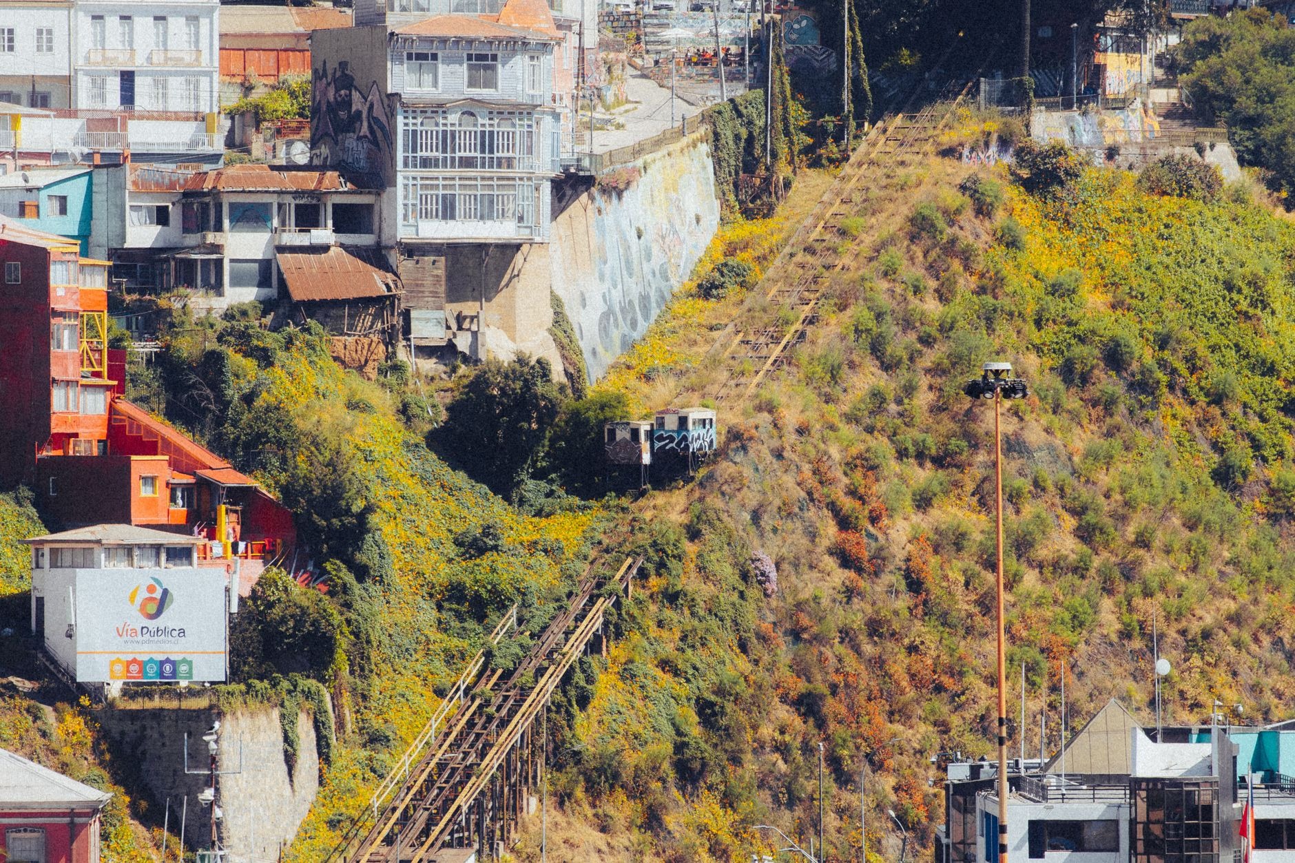 Vibrant hillside street murals and colorful corrugated metal houses on Cerro Alegre in Valparaíso Chile