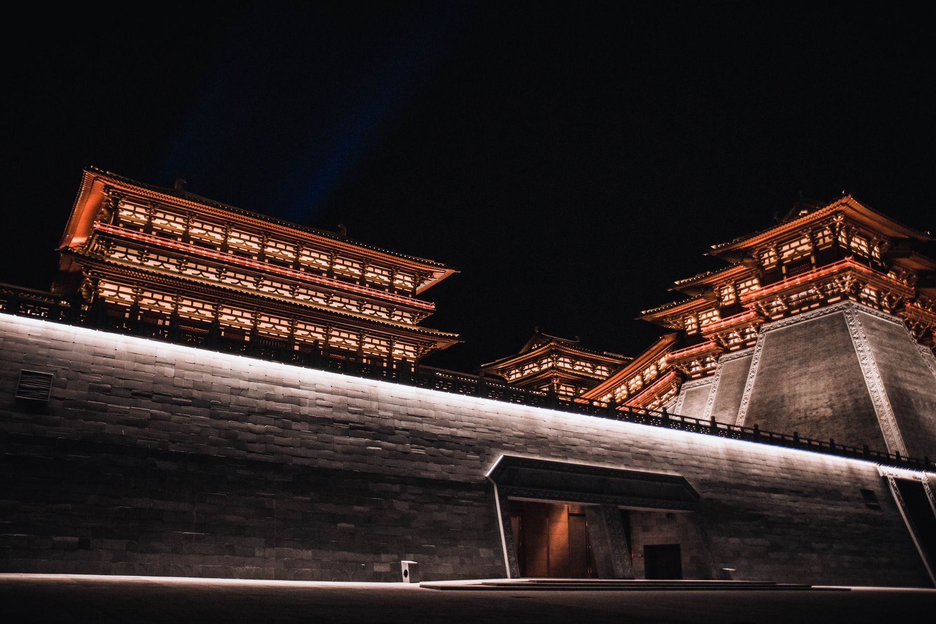 Illuminated traditional Chinese roof pavilions and massive fortified red-brick bastions along the ancient Xi'an City Wall