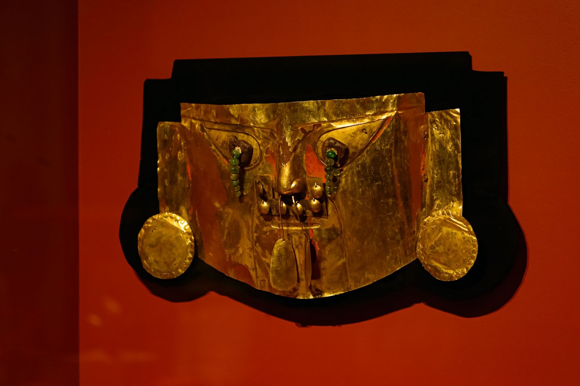 Intricately cast ancient pre-Columbian gold ceremonial breastplate and pectoral artifacts exhibited at the Museo del Oro in Bogotá