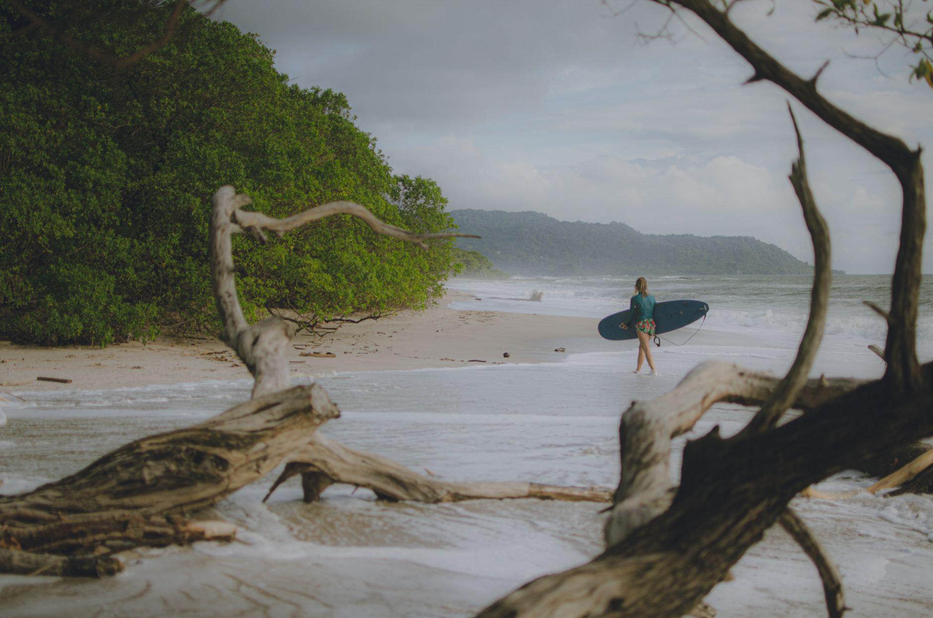 Pacific ocean waves rolling onto a golden Costa Rican surf beach