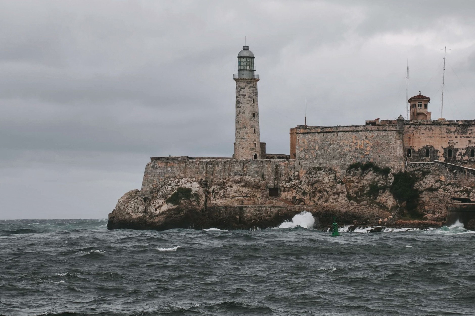 The historic stone fortifications and lighthouse of Castillo del Morro overlooking Havana harbor channel