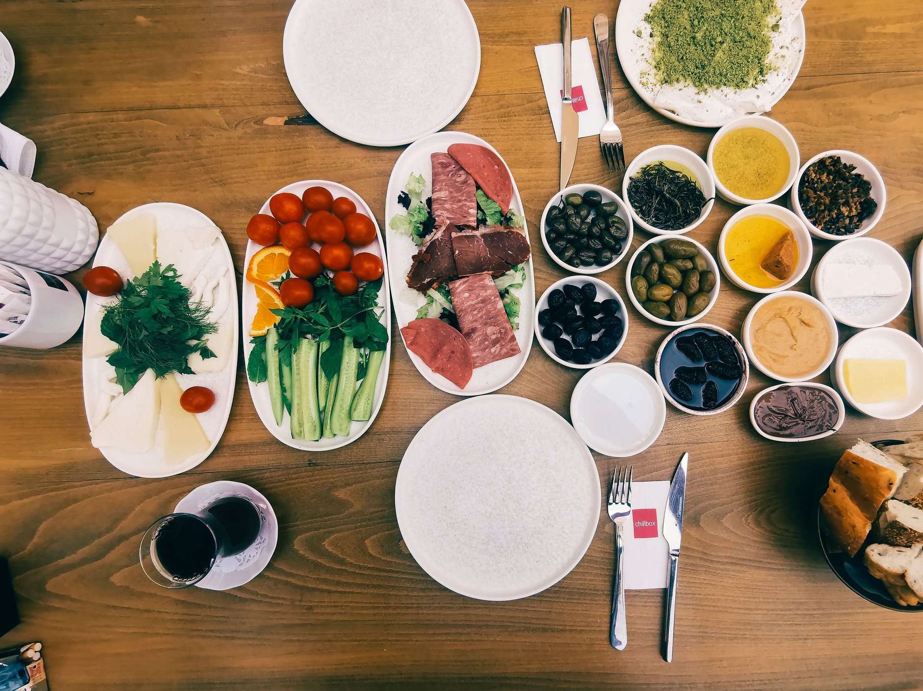 Traditional Cypriot meze spread featuring grilled halloumi cheese, village salad with feta, olives, dips, and warm flatbreads