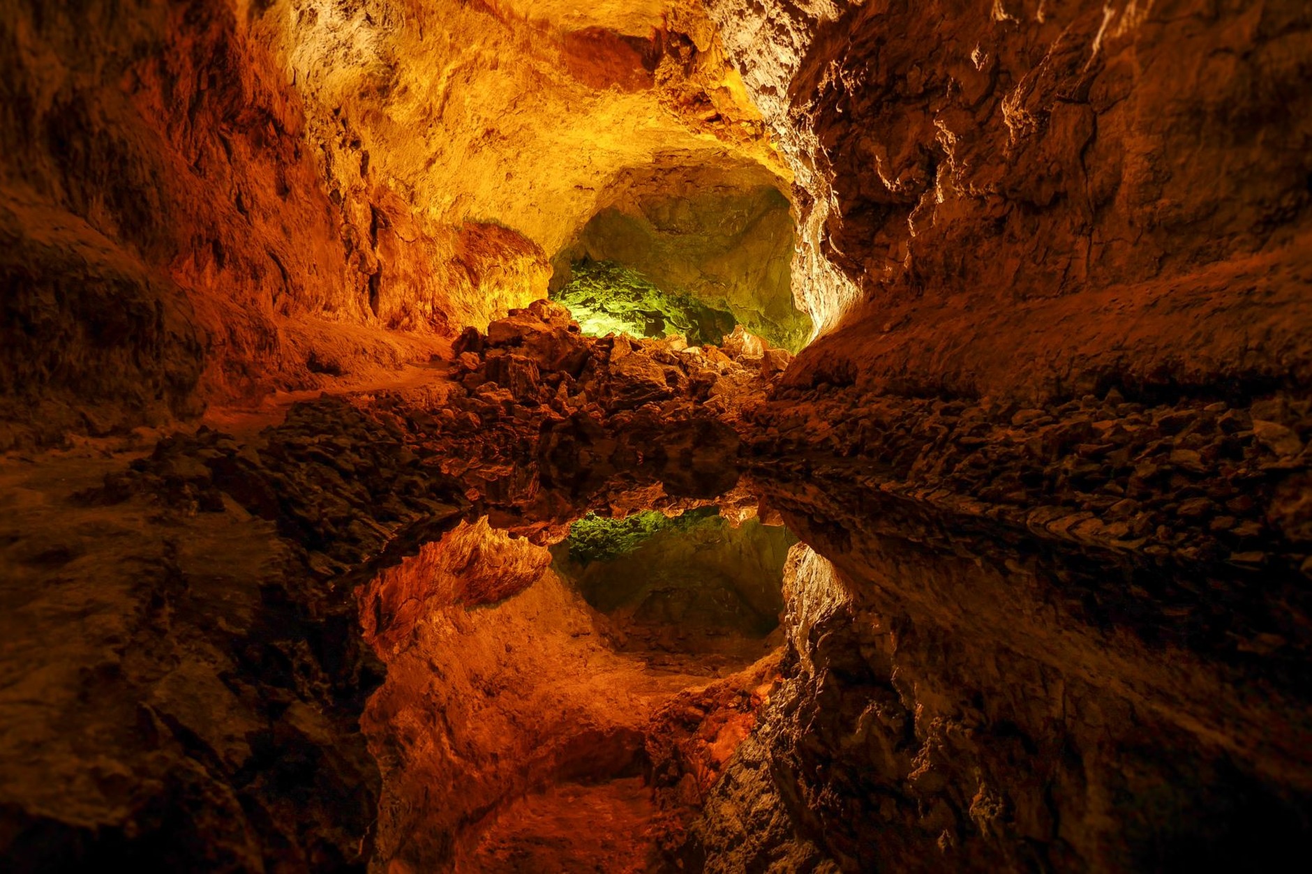Subterranean emerald limestone cenote and tropical hanging stalactites inside Los Tres Ojos National Park