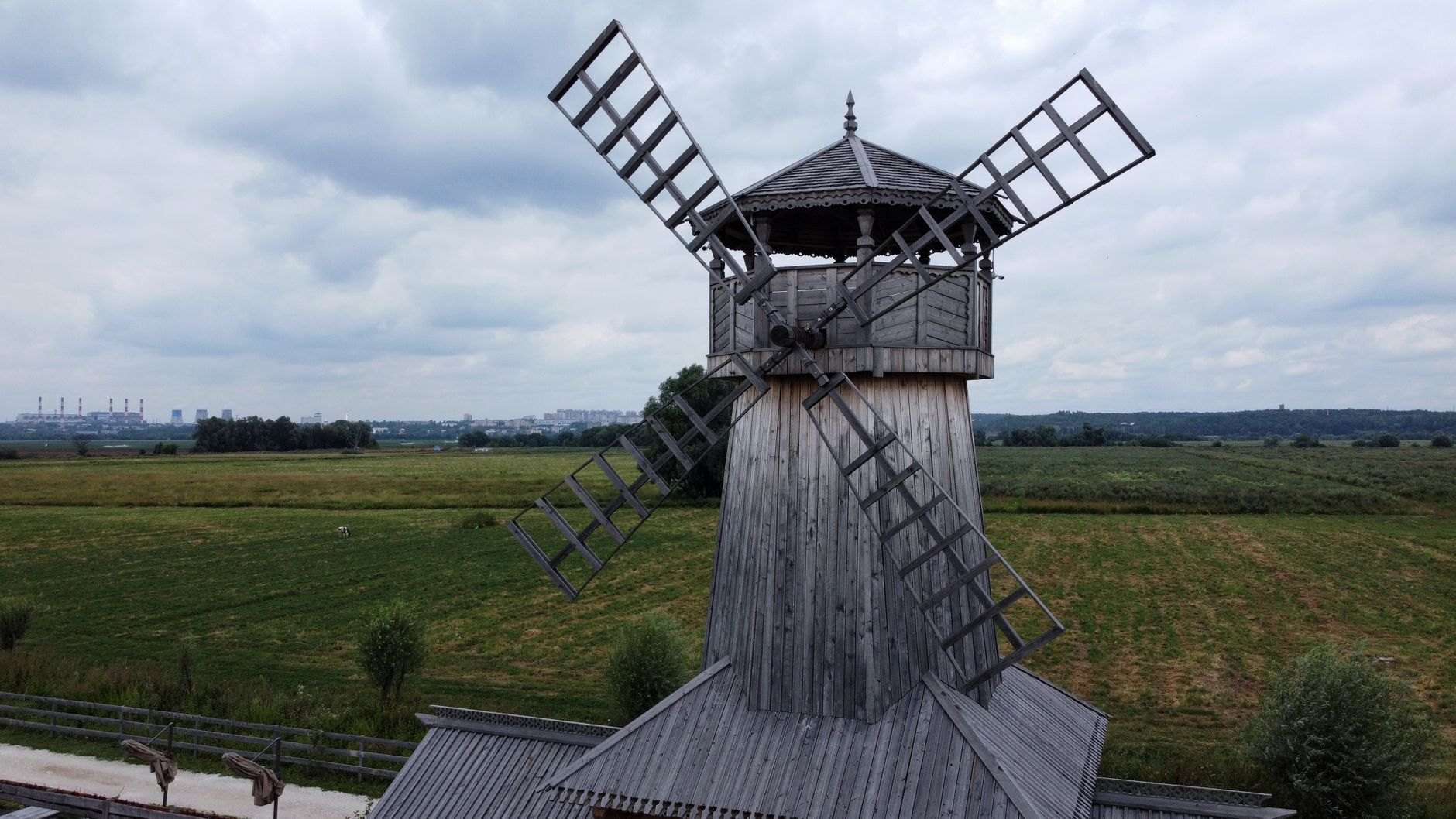 Trestle-style traditional wooden windmills standing in a grassy meadow on the island of Saaremaa